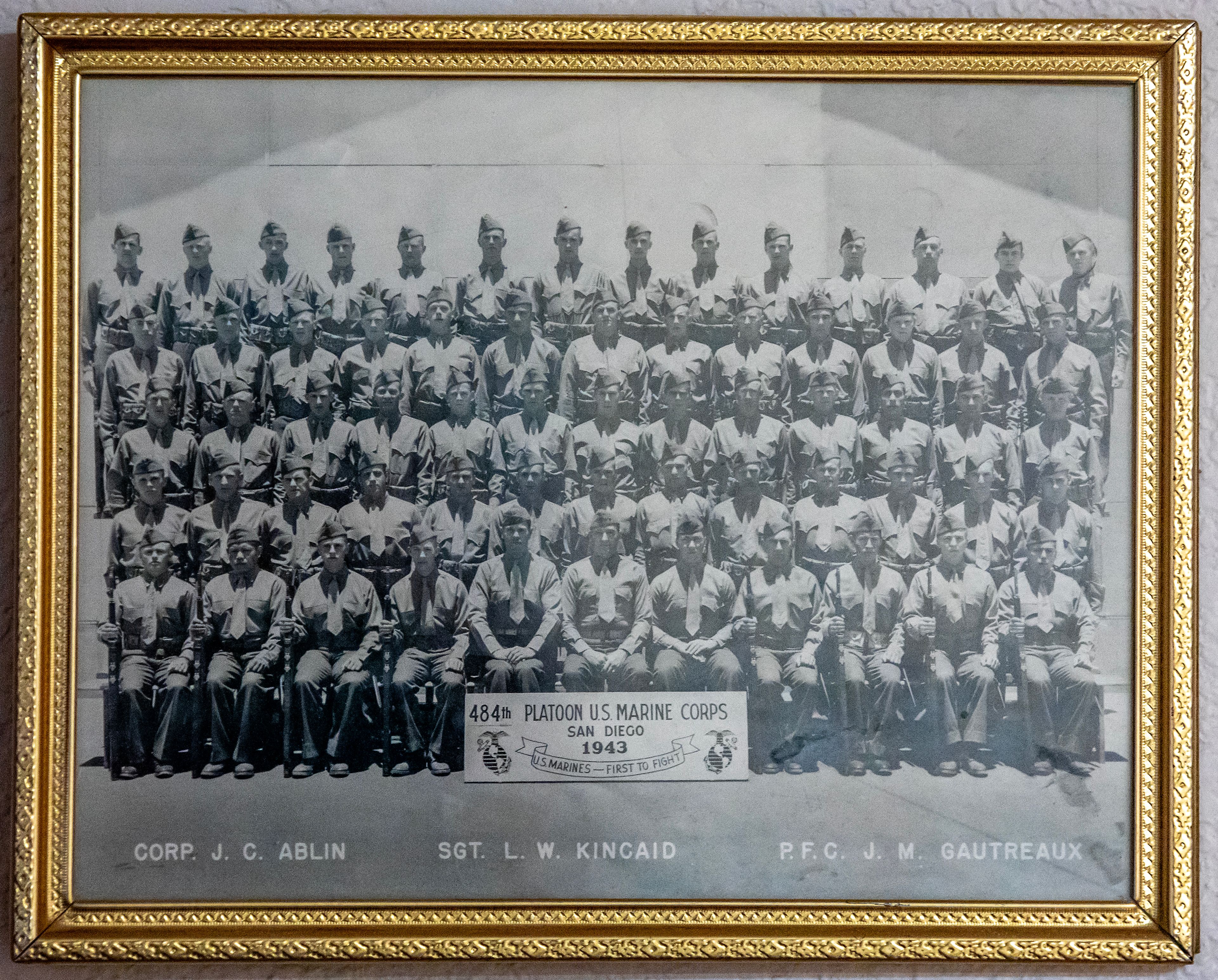 A picture showing Johnny Wells' Marine Corps platoon is displayed at his apartment Tuesday in Clarkston. Wells is at at the left end of the bottom row.