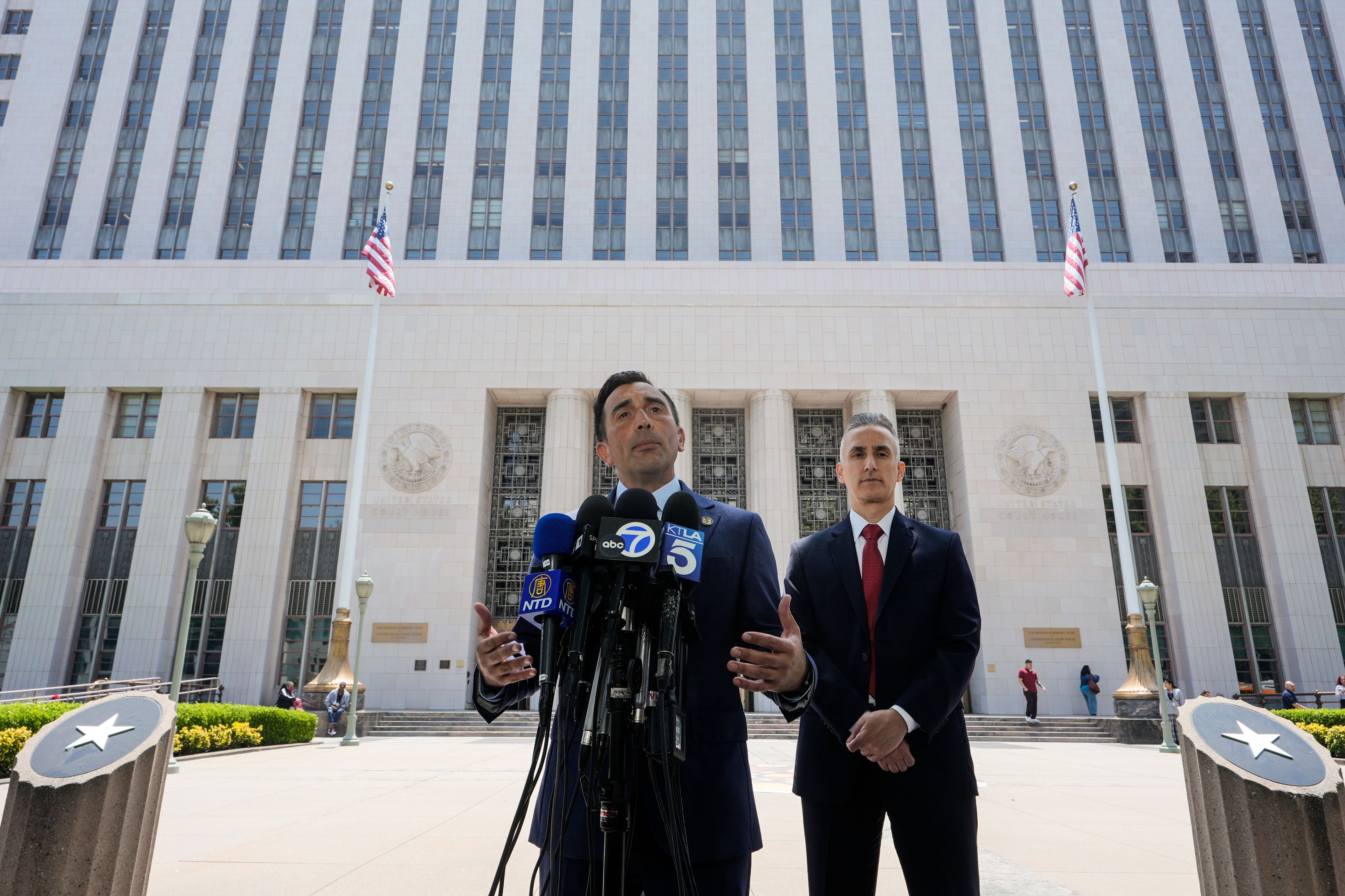 U.S. Attorney Martin Estrada, center, speaks as federal prosecutor Jeff Mitchell, listens at right, during a news conference in Los Angeles Tuesday, June 4, 2024. Ippei Mizuhara, the former interpreter for Los Angeles Dodgers star Shohei Ohtani, pleaded guilty to bank and tax fraud on Tuesday and admitted to stealing nearly $17 million from the Japanese baseball player to pay off sports betting debts.