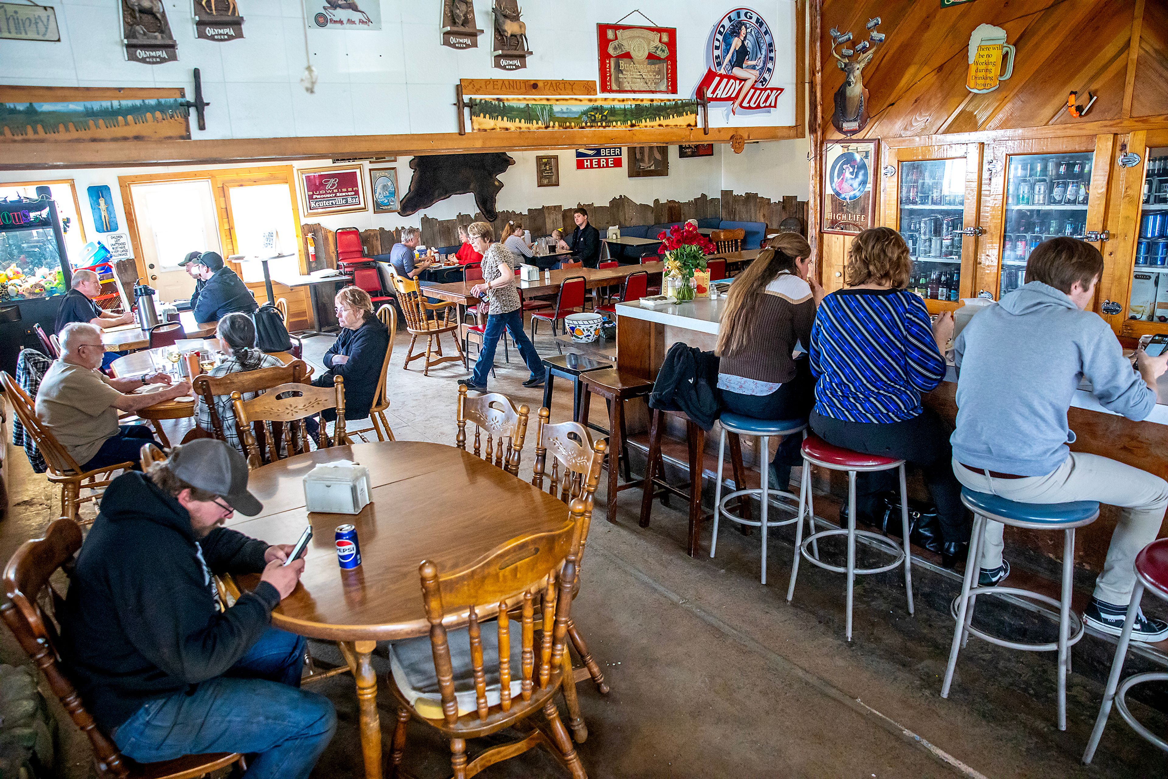 Linda Elliott makes her way through the Keuterville Pub & Grub during a busy lunch Thursday in Keuterville.