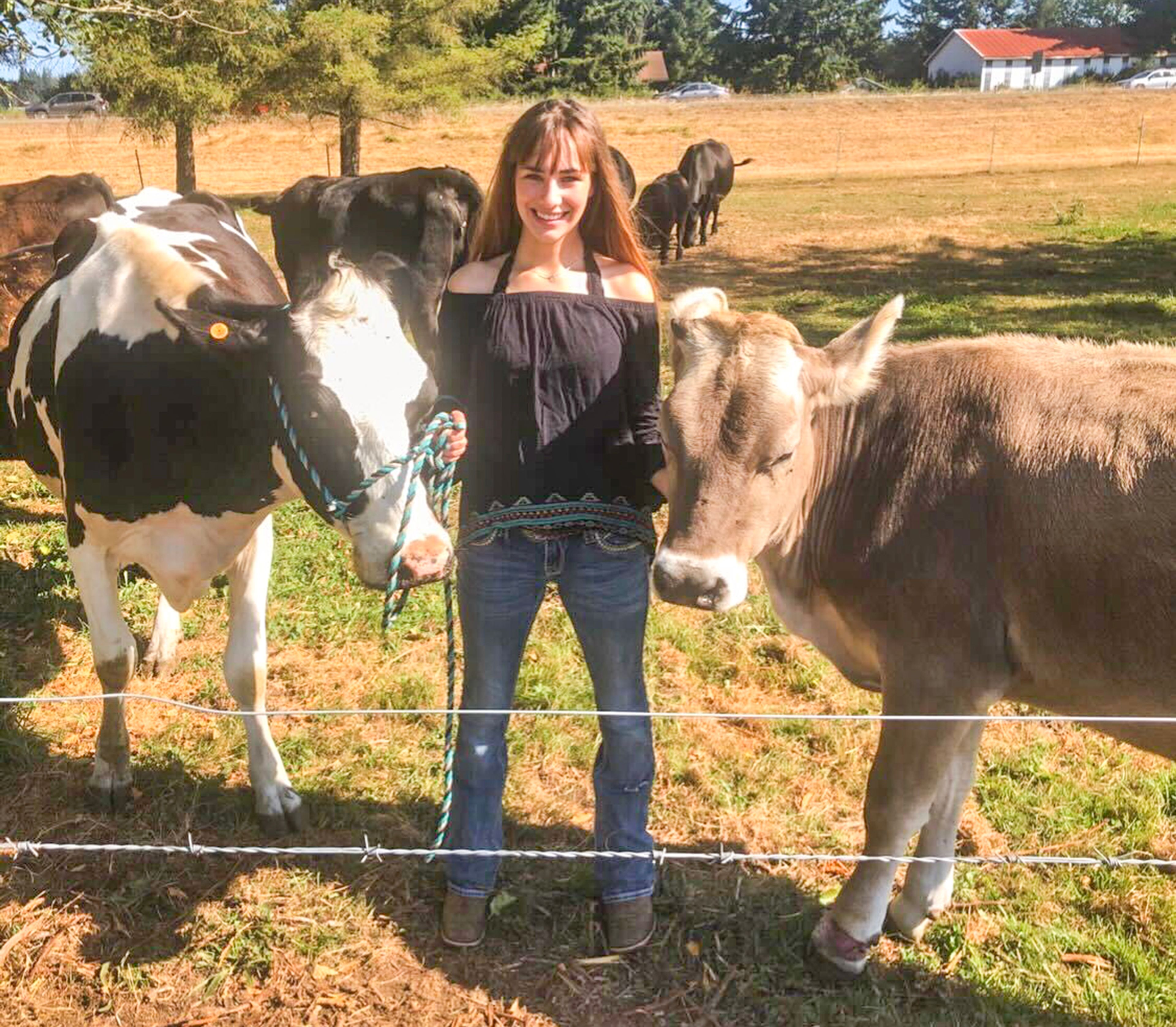 Emma Spalding is pictured with two of her cows.