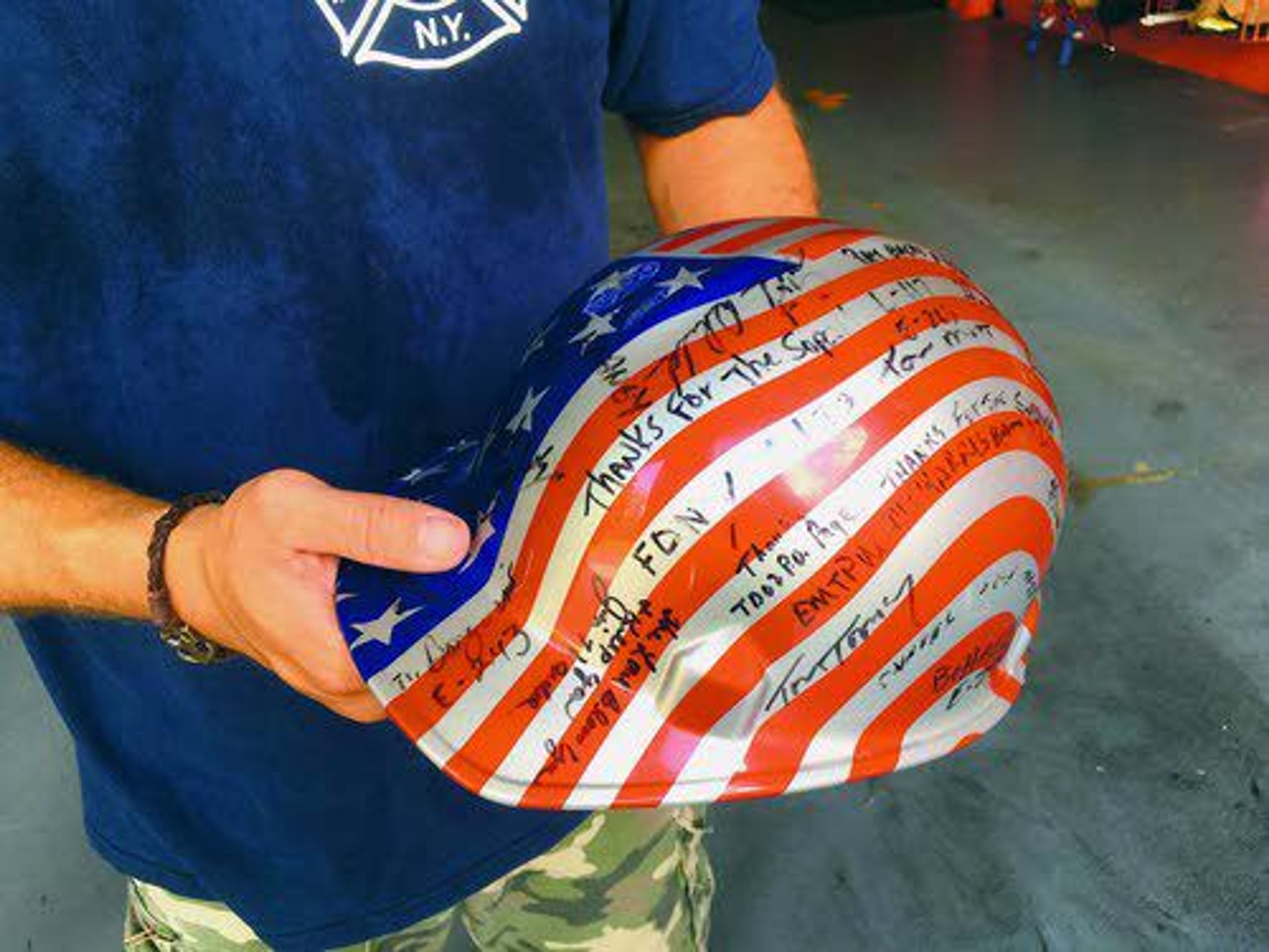 In this Aug. 19 photo, Jon Hile, of Louisville, Ky., holds a hard hat with signatures from friends he met during his time volunteering at ground zero in Manhattan after the attacks of Sept. 11, 2001.