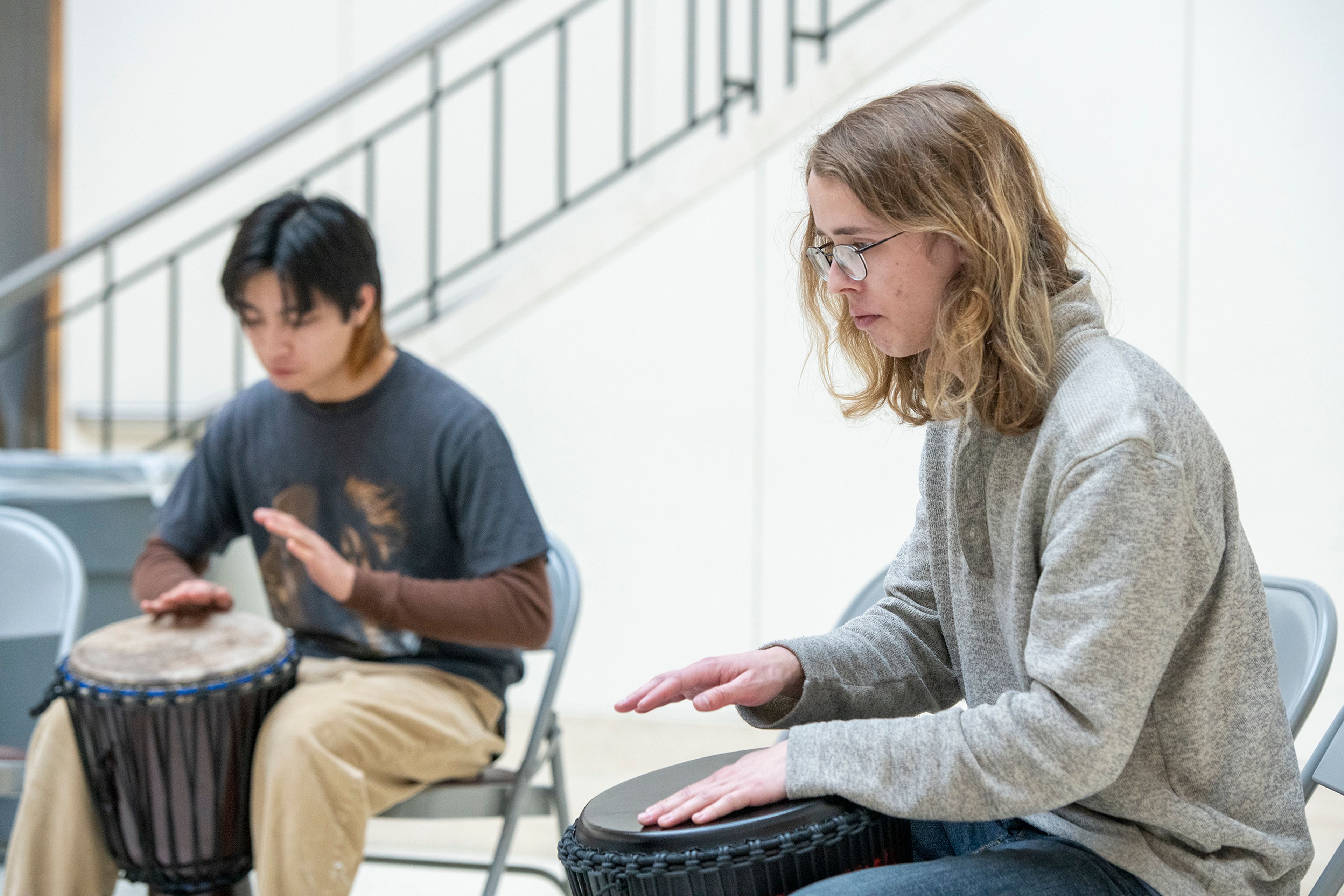 Gage Amonette, right, participates in a drum circle Tuesday at Washington State University’s Terrell Library Atrium in Pullman for the National Day of Racial Healing.