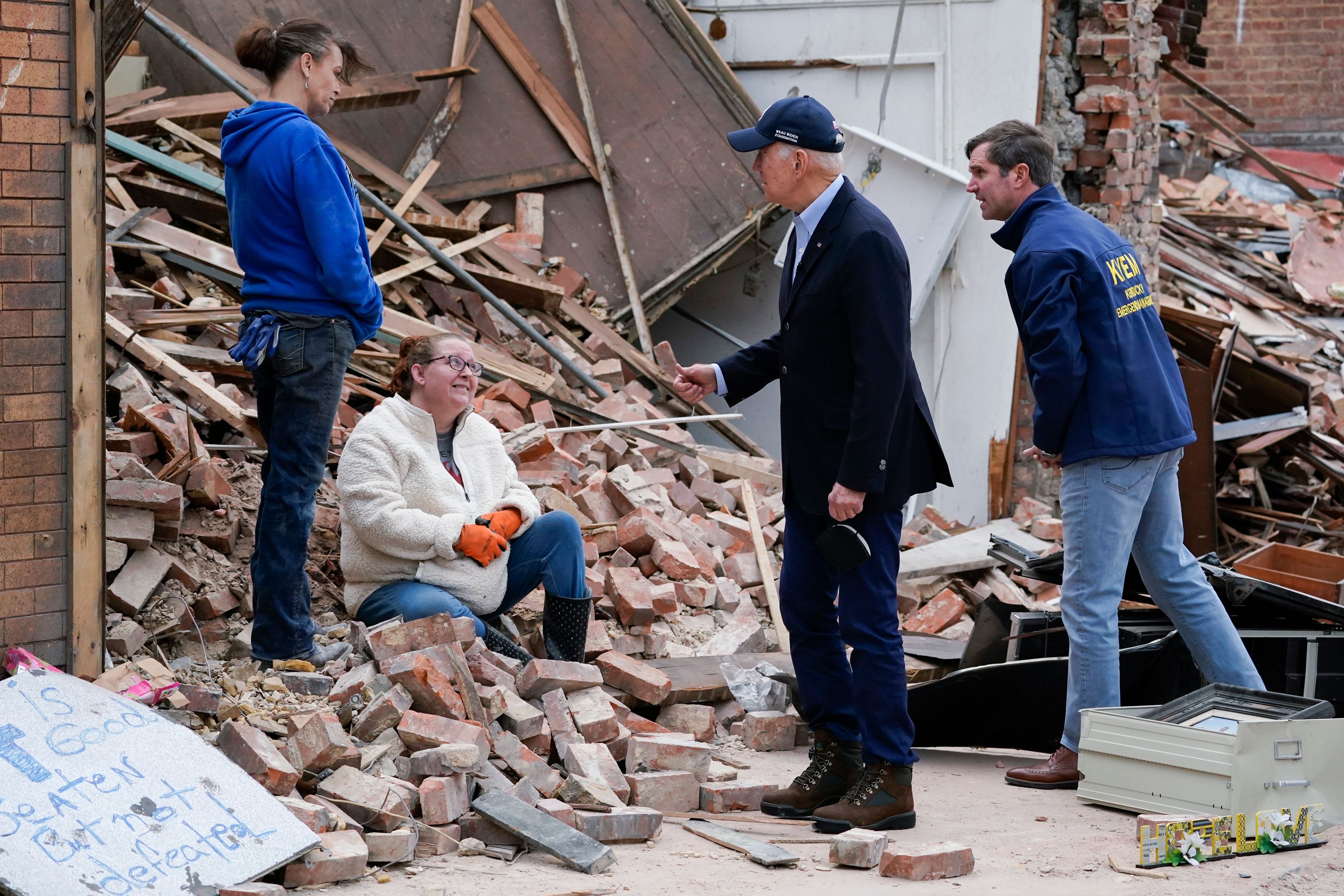 FILE - President Joe Biden and Kentucky Gov. Andy Beshear talk to people as they survey storm damage from tornadoes and extreme weather in Mayfield, Ky., Wednesday, Dec. 15, 2021. Beshear says a rental housing shortage has gnawed at him since the recovery began from a tornado outbreak that hit western Kentucky in 2021. On Monday, June 3, 2024, Beshear unveiled plans to build 953 rental housing units in four counties — Christian, Graves, Hopkins and Warren.