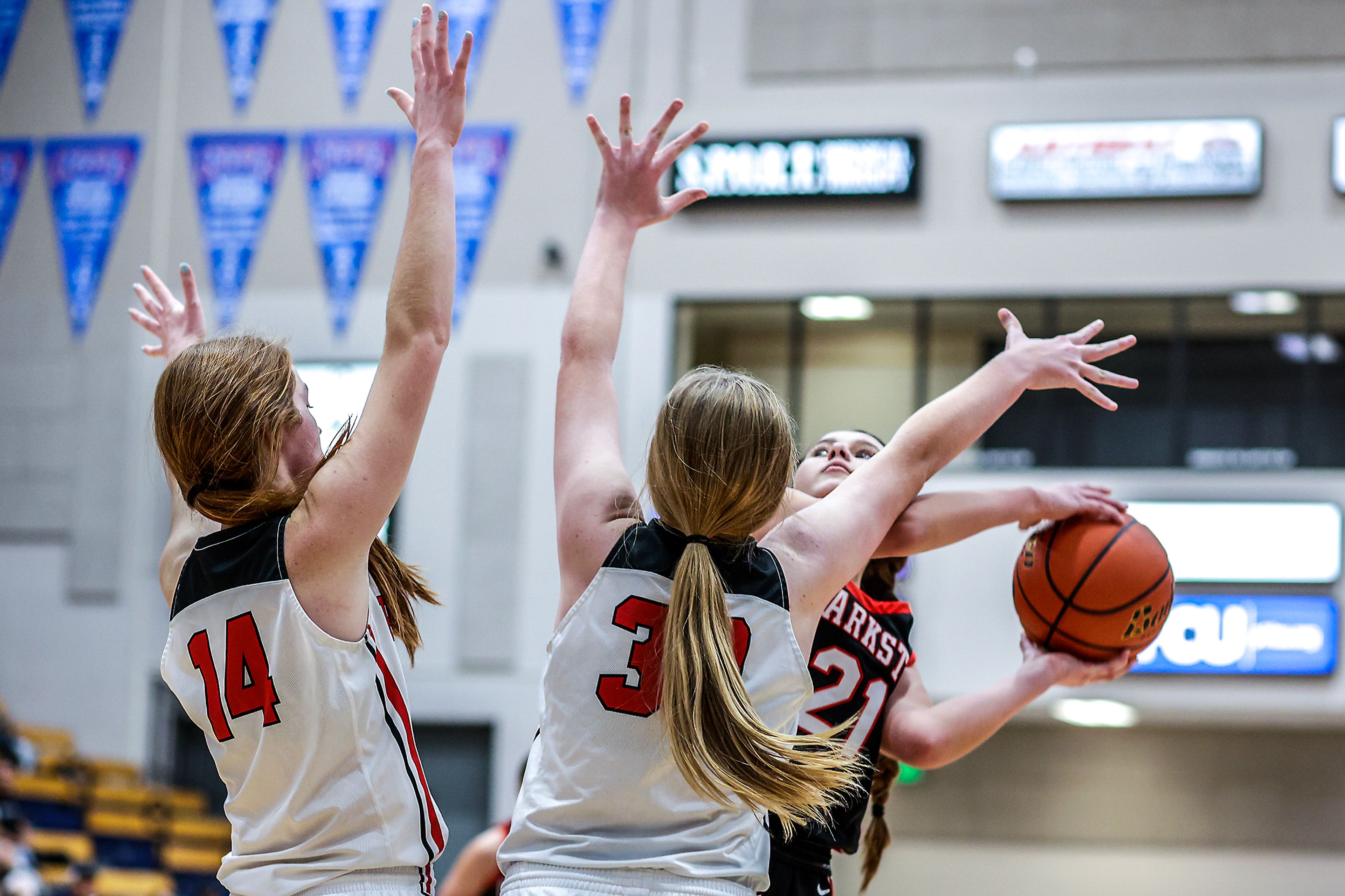 Clarkston wing Ella Leavitt looks for a path to the basket as Prairie post Tara Schlader, left, and guard Hailey Hanson defends during the Avista Holiday Tournament on Wednesday.