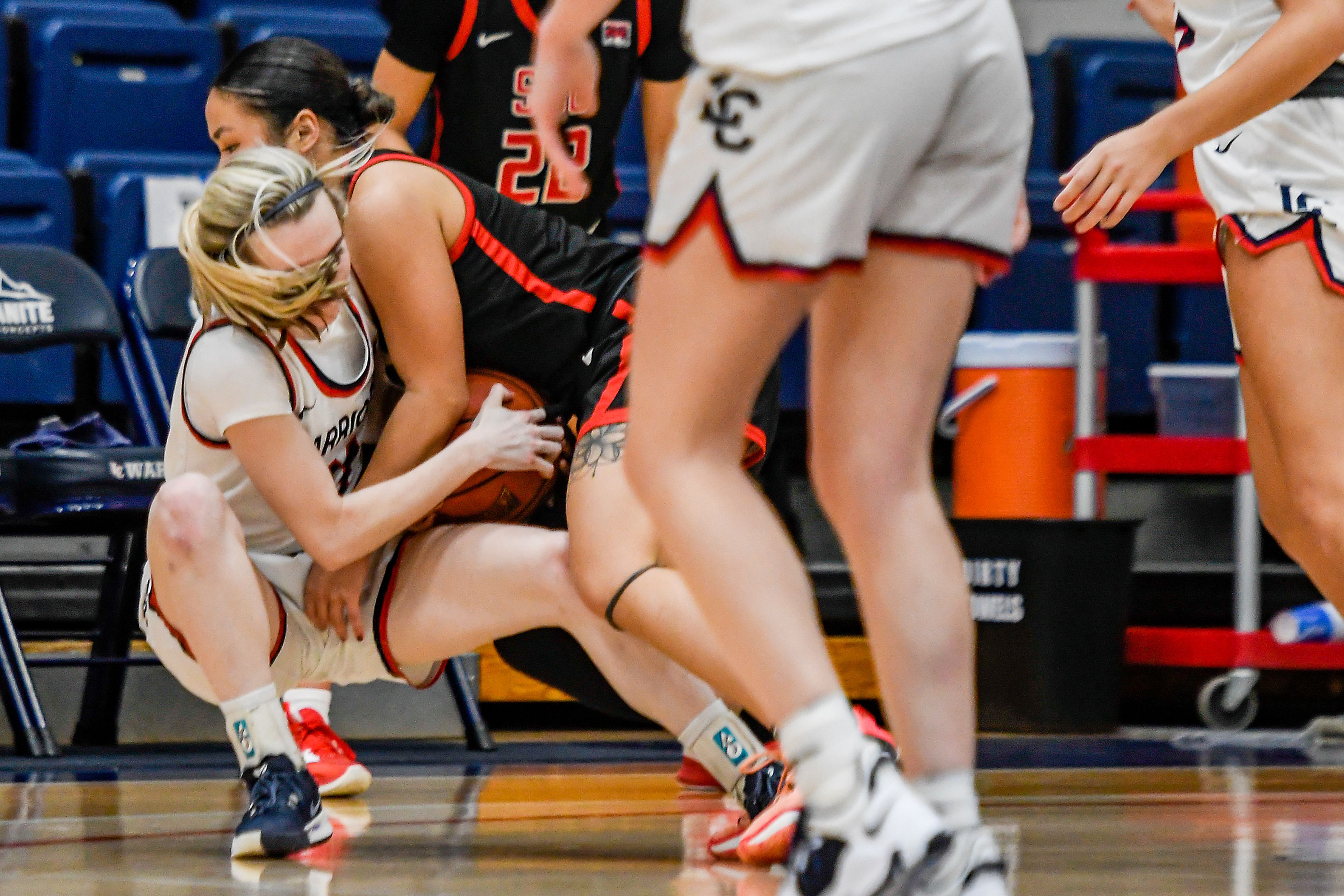 Lewis-Clark State guard Callie Stevens, left, and Southern Oregon guard Brianna Phiakhamngon fight for possession of the ball during Saturday's Cascade Conference game at the P1FCU Activity Center.