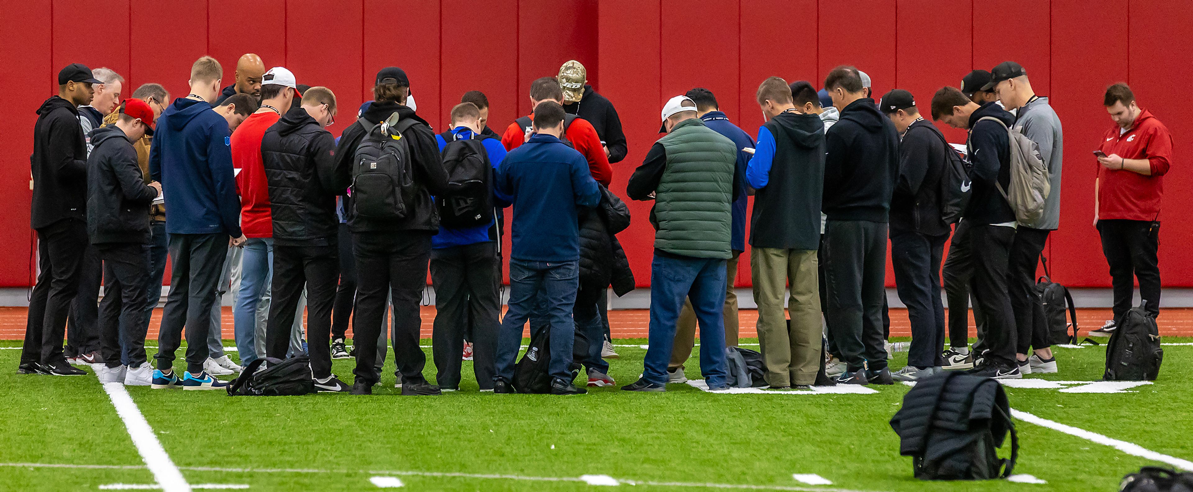 NFL Scouts group up before the next phase of testing during Washington State University’s Pro Day Friday Pullman.