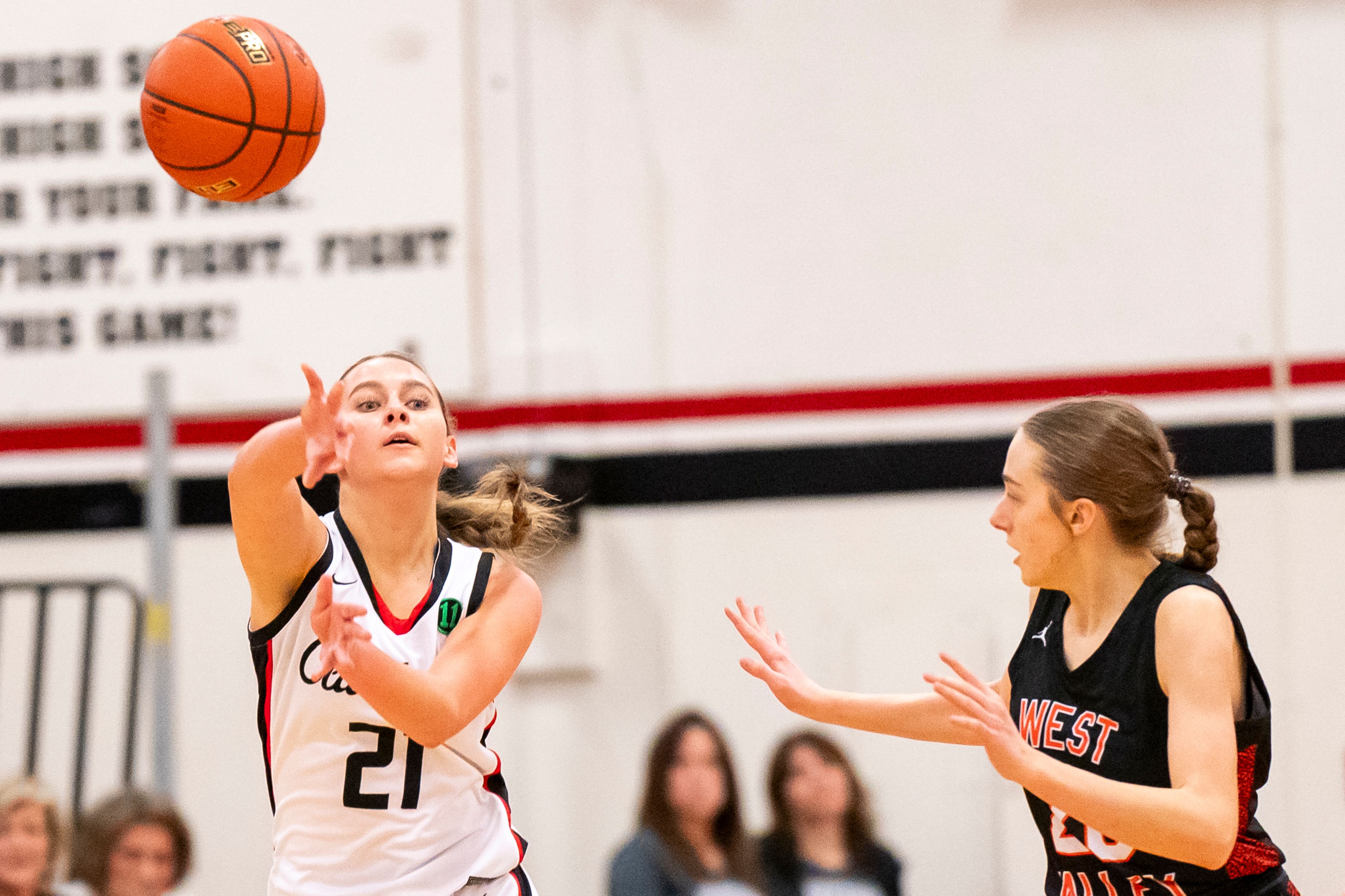 Clarkston’s Ella Leavitt (21) passes the ball during a girls 2A district championship game against West Valley on Feb. 17 at Clarkston High School.