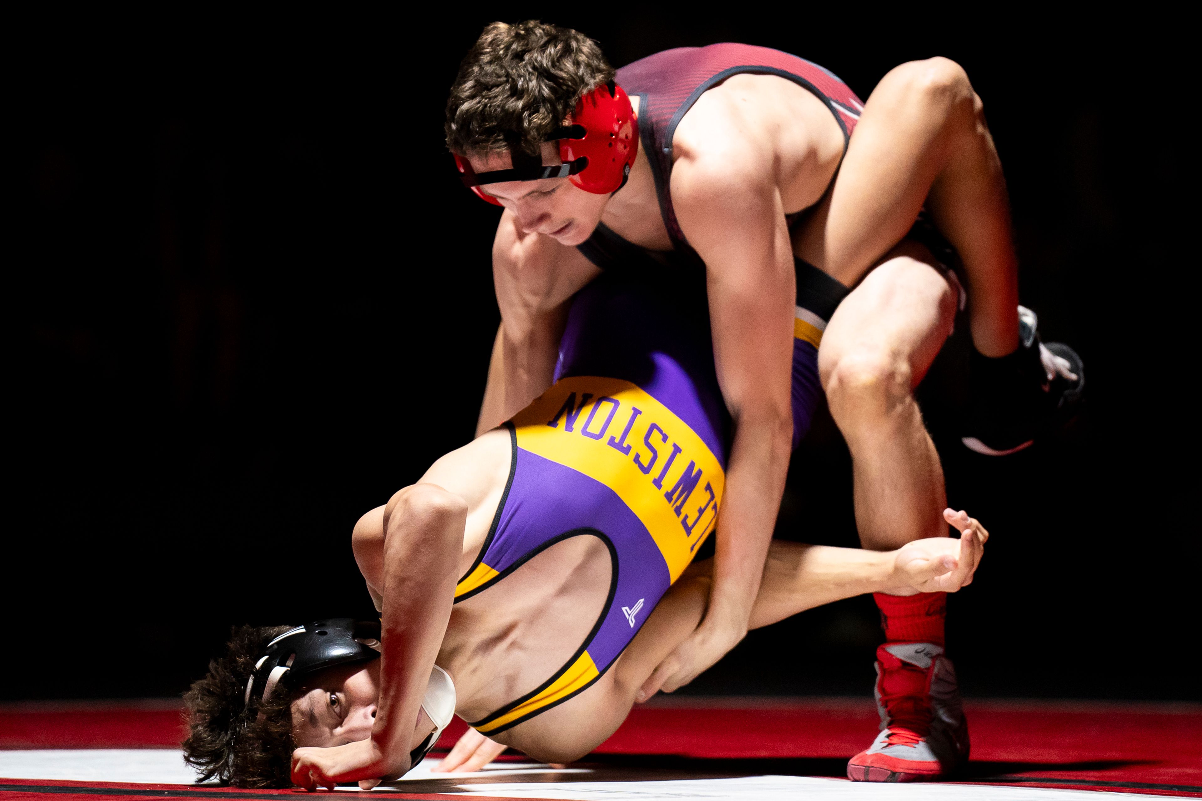 Clarkston’s Gabe Weza, right, grabs hold of Lewiston’s Christ Porter during a 126-pound match Wednesday at Kramer Gym in Clarkston.