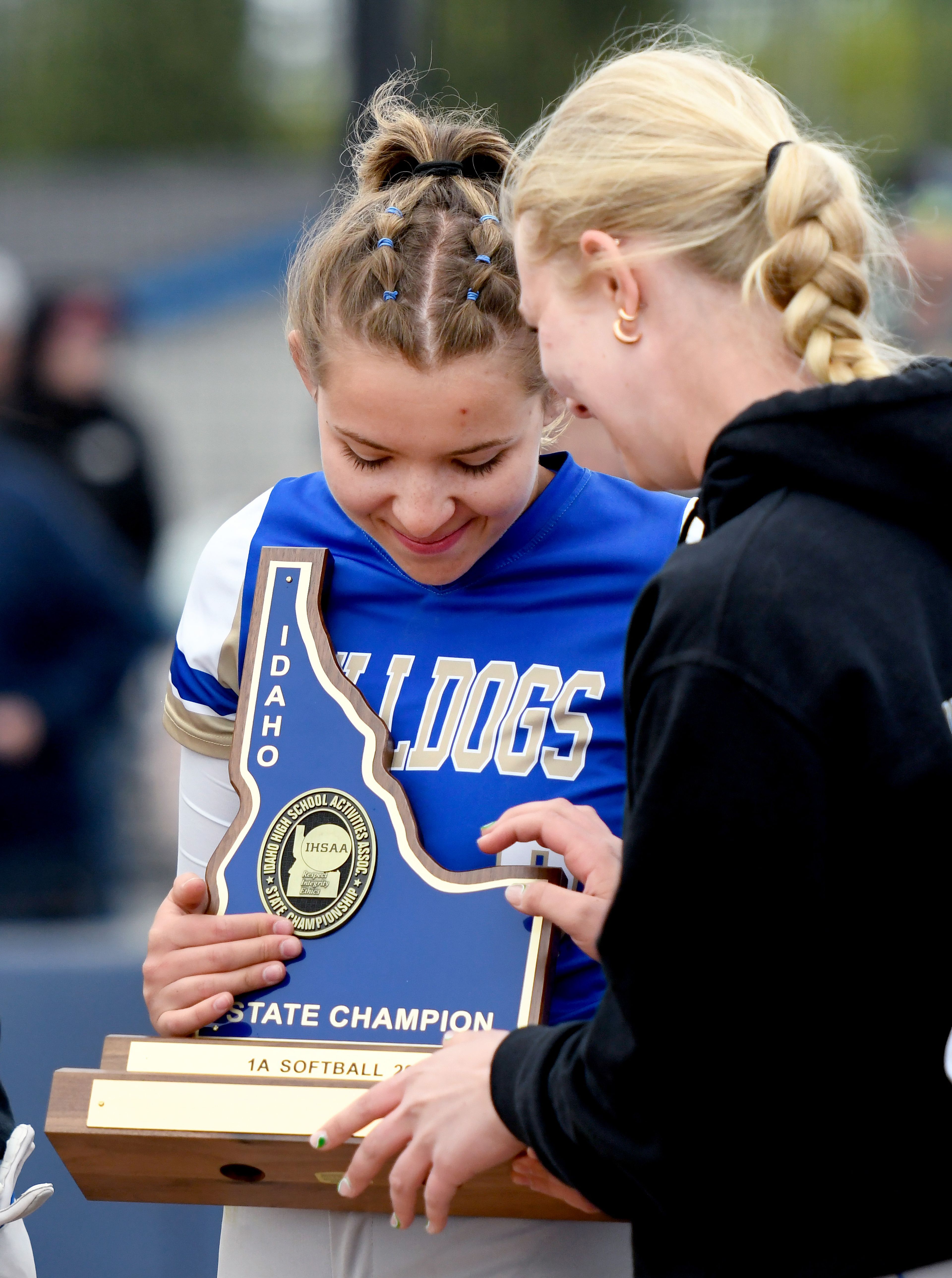 Genesee’s Mia Scharnhorst looks down at the state champion trophy after a win over Kendrick in an Idaho Class 1A state championship Friday in Genesee.