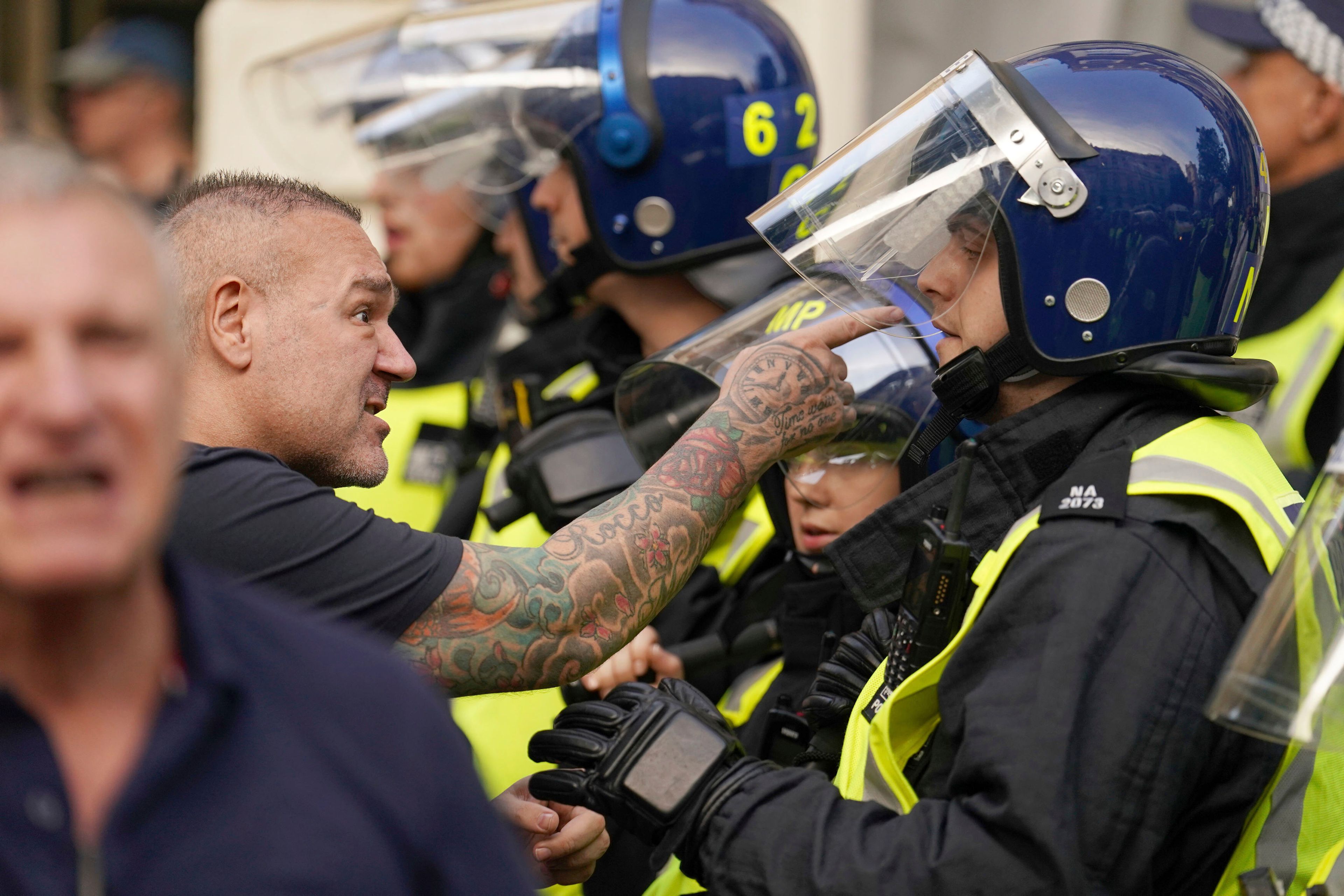 A protester points his finger towards a police officer during the 'Enough is Enough' protest in Whitehall, London, Wednesday July 31, 2024, following the fatal stabbing of three children at a Taylor Swift-themed holiday club on Monday in Southport. (Jordan Pettitt/PA via AP)