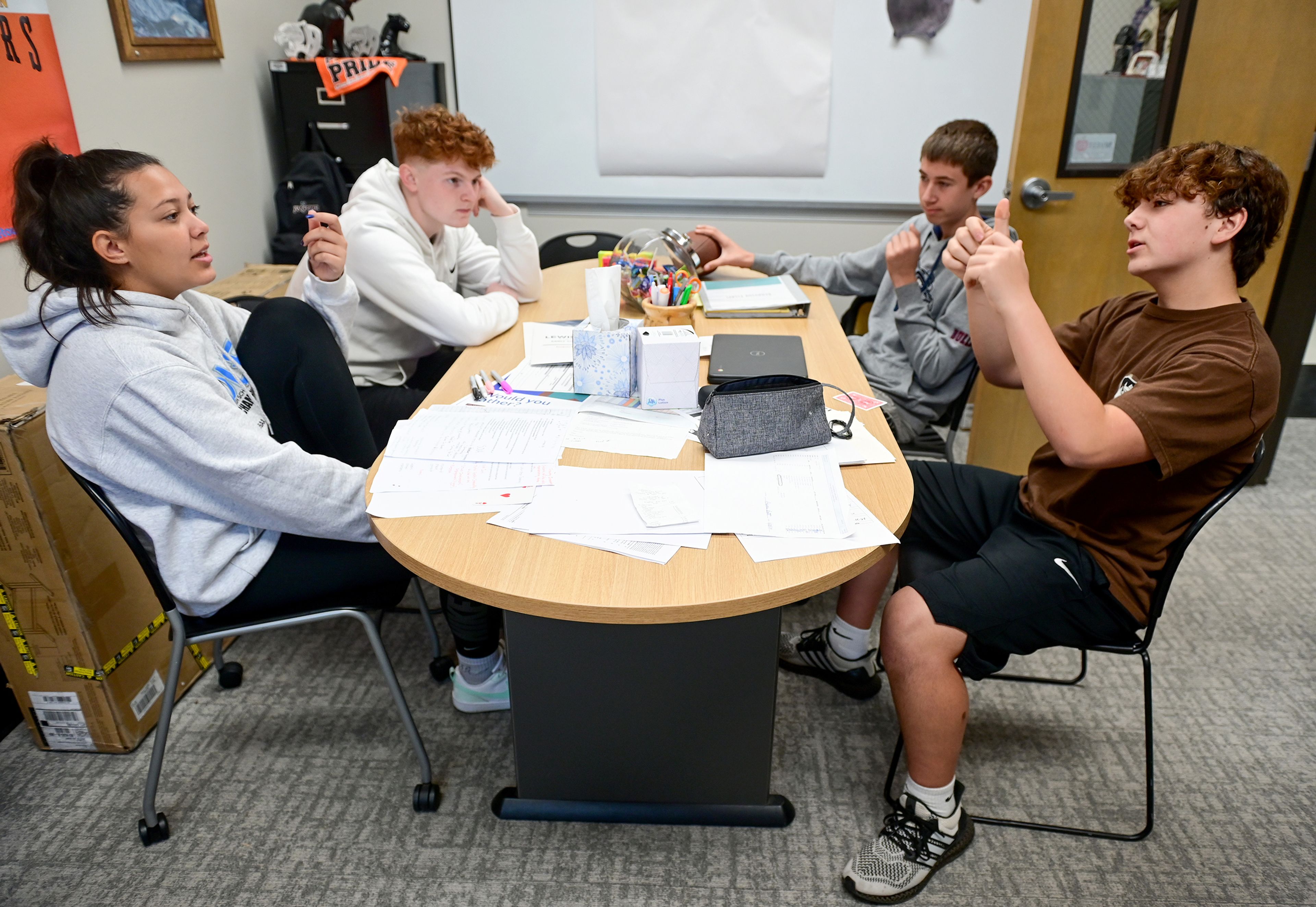 Jazmyn Smith, from left, a senior at Lewiston High School, Brady Rudolph, a sophomore at LHS, Carson Henson, a freshman at LHS and Gavin Hinkley, a freshman at Asotin High School, discuss community issues and possible solutions during a small groups portion of a Students of the Valley Advocacy meeting Monday at AHS.,