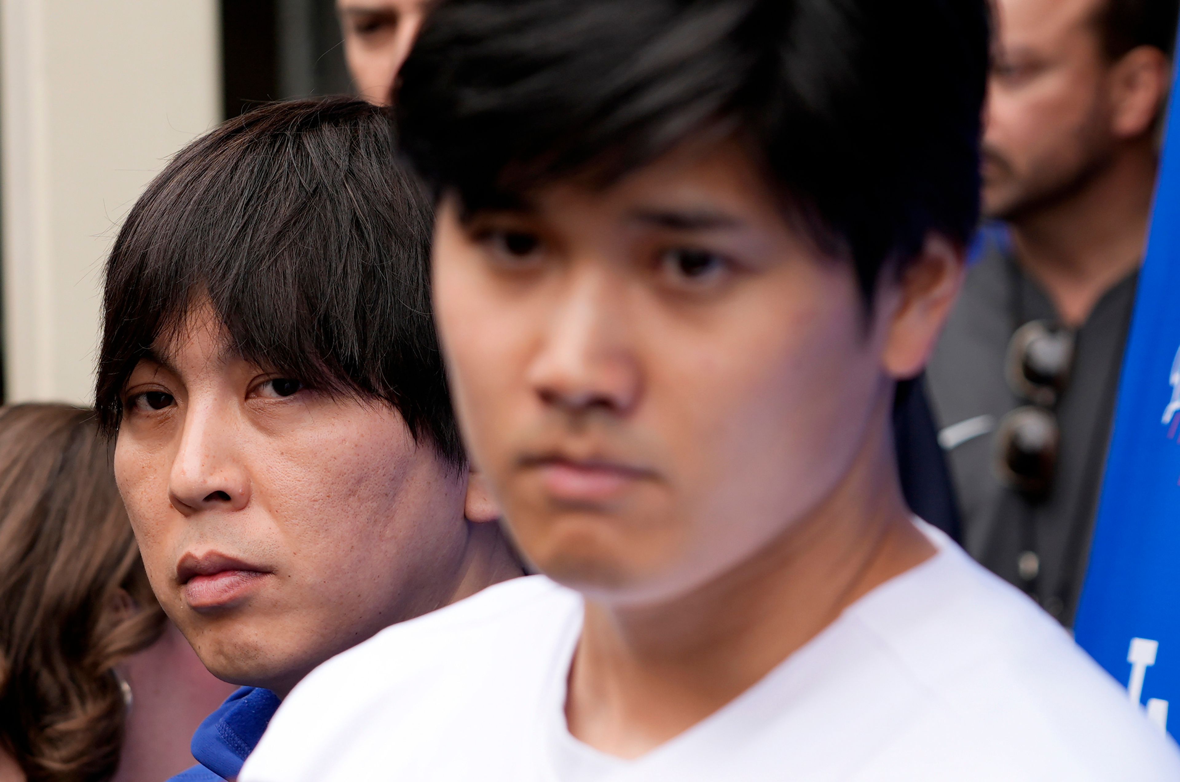 FILE - Interpreter Ippei Mizuhara, left, stands behind Japanese baseball star Shohei Ohtani, front right, and translates during an interview at Dodger Stadium, Feb. 3, 2024, in Los Angeles. Mizuhara is scheduled to plead guilty Tuesday, June 4, 2024, to bank and tax fraud in a sports betting case where he is expected to admit to stealing nearly $17 million from the Japanese baseball player.