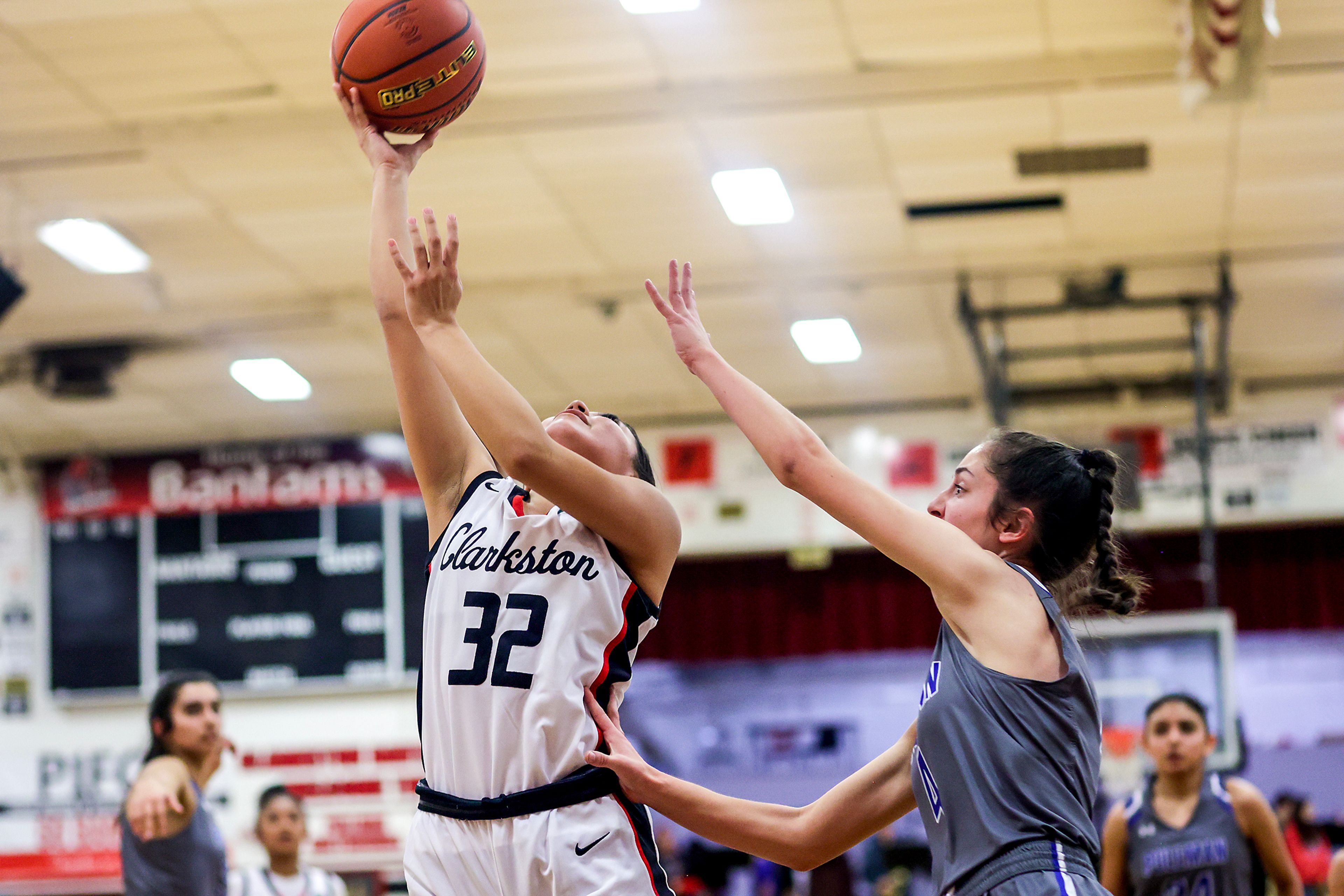 Clarkston guard Alexia Villavicencio, left, shoots the ball as Pullman guard Jennabee Harris defends during Tuesday's Class 2A Greater Spokane League girls basketball game.