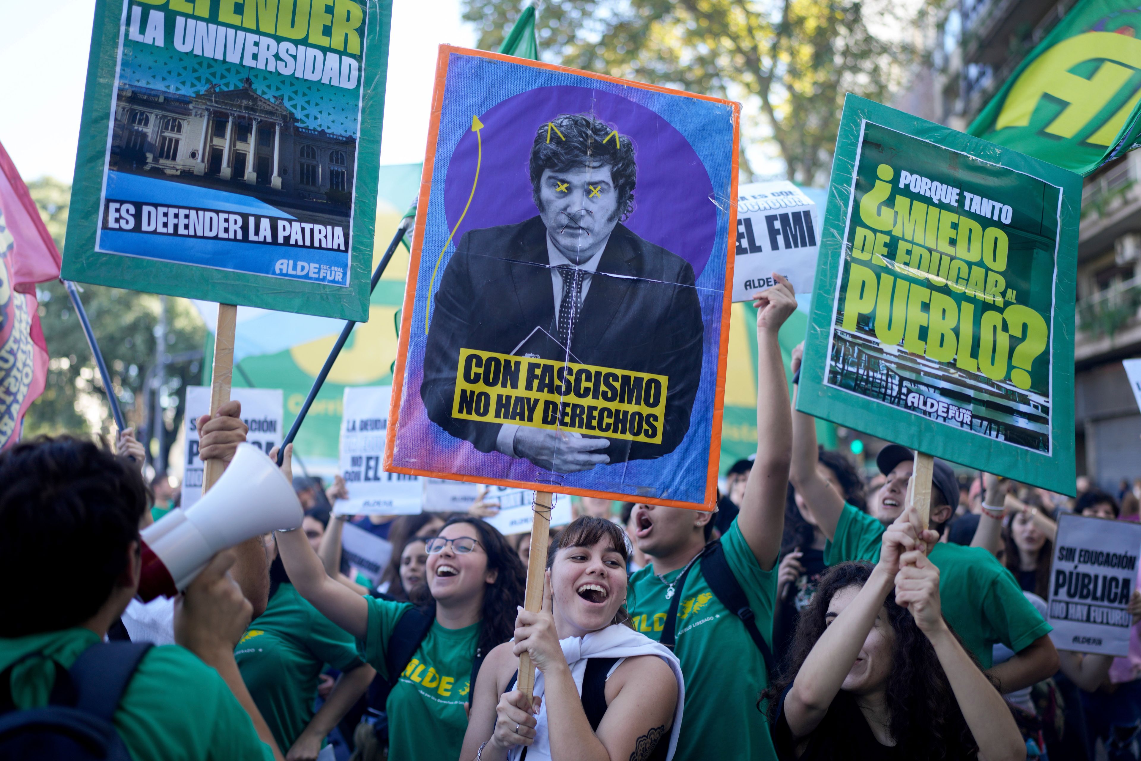 FILE - Students protest for more public university funding and against austerity measures proposed by President Javier Milei, featured on the sign, in Buenos Aires, Argentina, April 23, 2024. (AP Photo/Natacha Pisarenko, File)