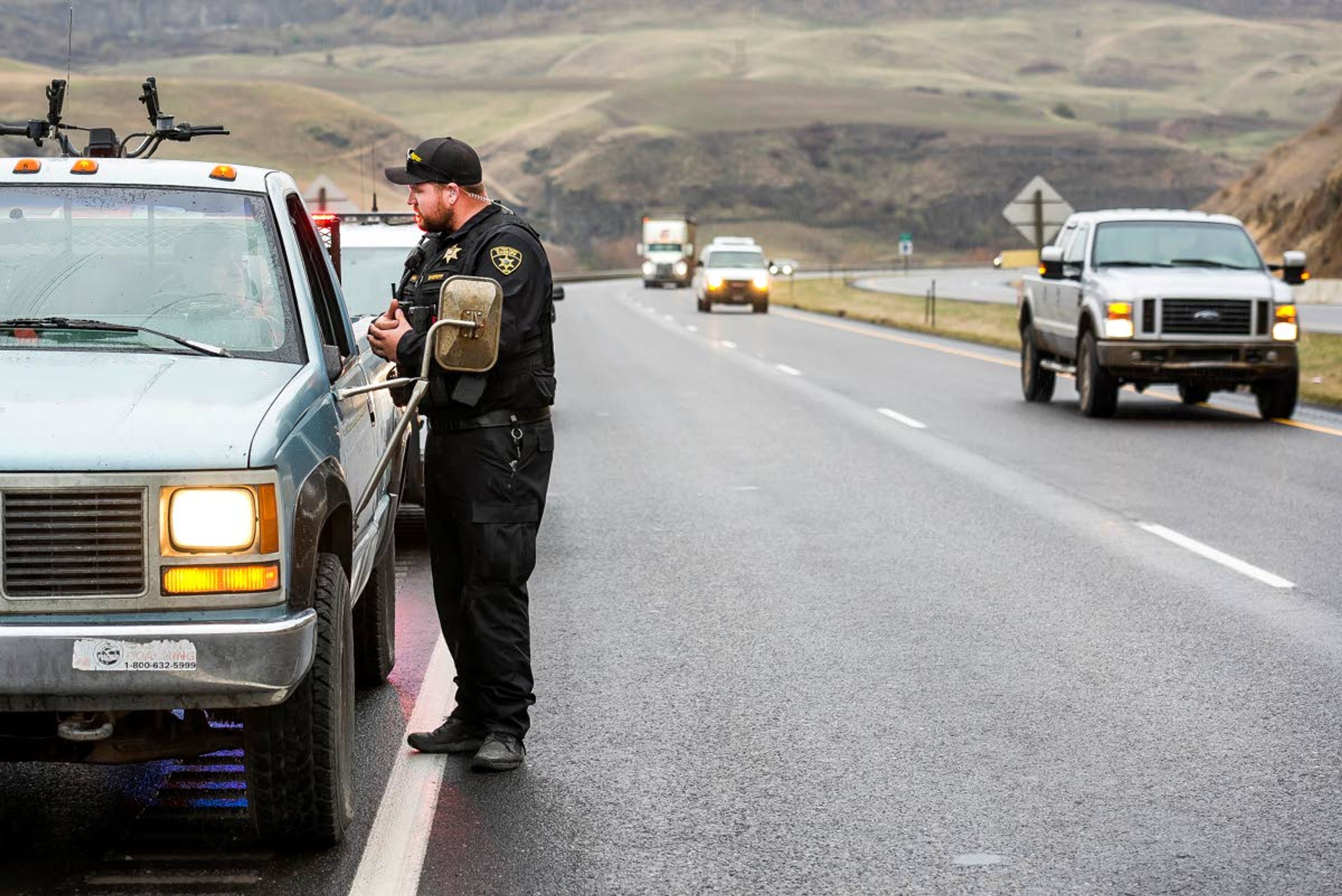 Nez Perce County Sheriff’s Office deputy Cody Hays tells a driver about the Move Over law expansion as traffic safely passes in the left lane on U.S. Highway 95/12 on Tuesday in Lewiston. Nez Perce County Sheriff’s Office and Idaho State Police spent time Tuesday afternoon pulling over drivers to alert them to changes in the law requiring drivers to slow down and move into a different lane for emergency vehicles and people stopped on the side of the road.