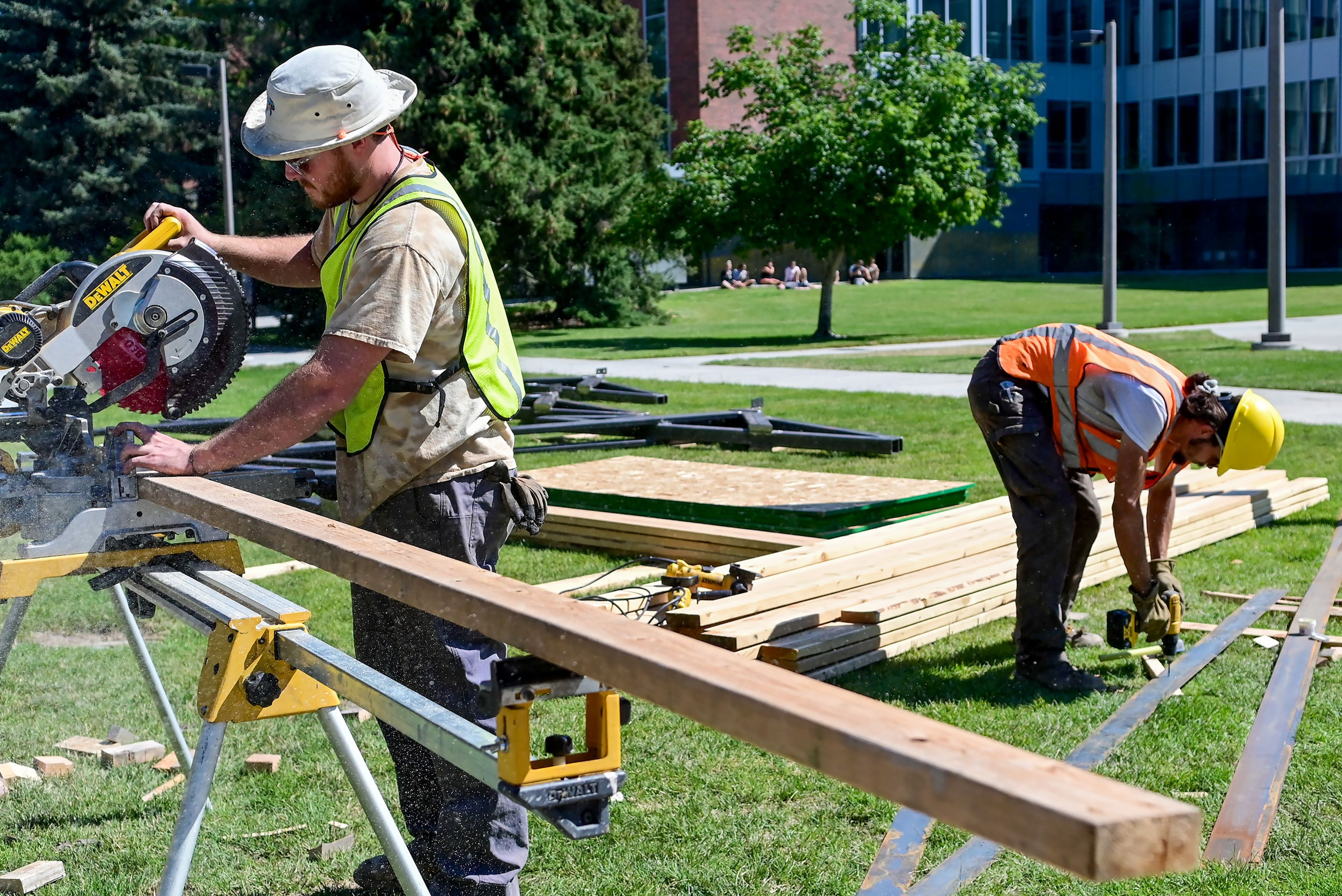 University of Idaho graduate architecture students David Wester, left, and Aaron Magalsky cut and drill pilot holes into materials for the Vandal Healing Garden and Memorial in Moscow on Tuesday.