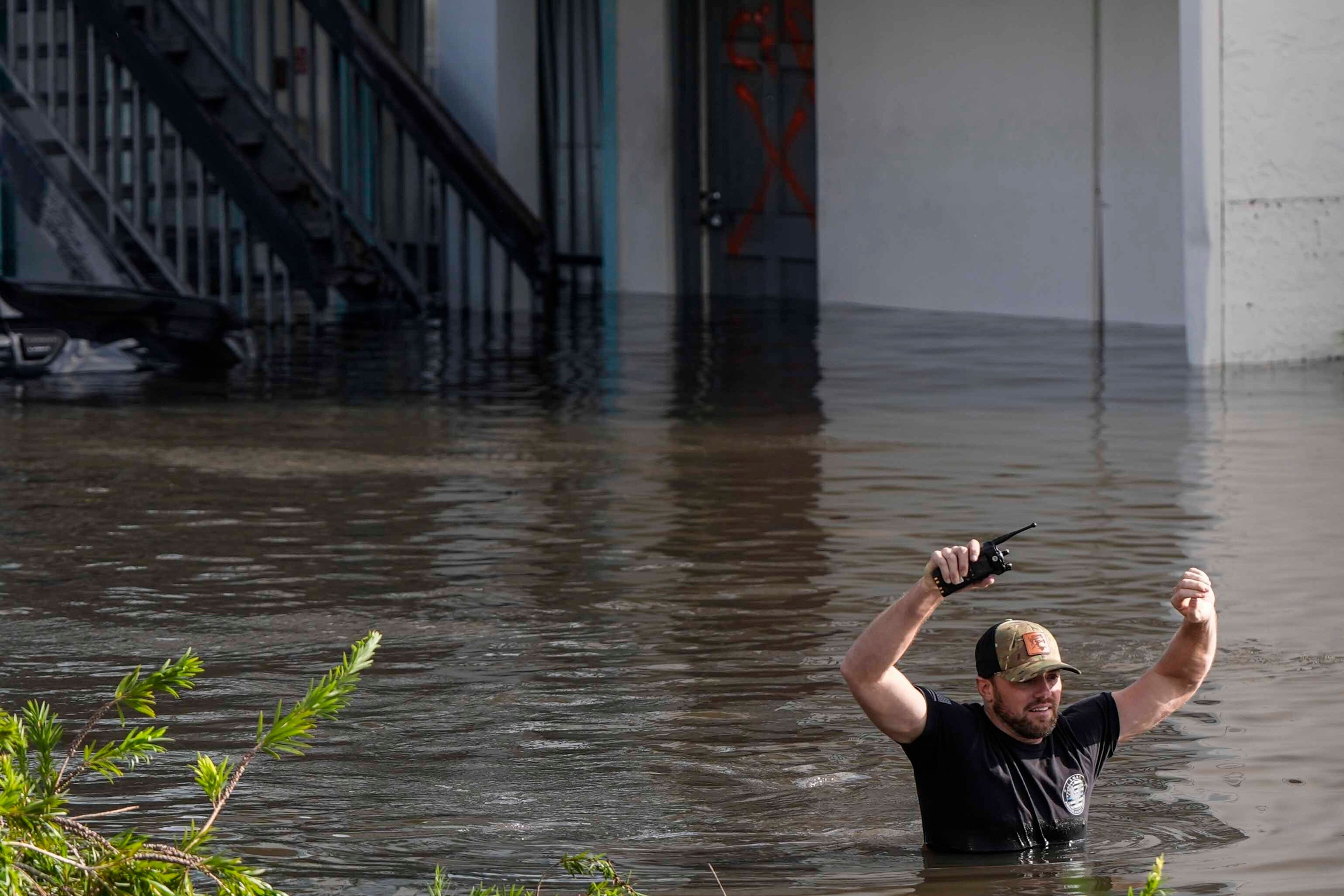 A water rescue team member walks through flood waters at an apartment complex in the aftermath of Hurricane Milton, Thursday, Oct. 10, 2024, in Clearwater, Fla. (AP Photo/Mike Stewart)