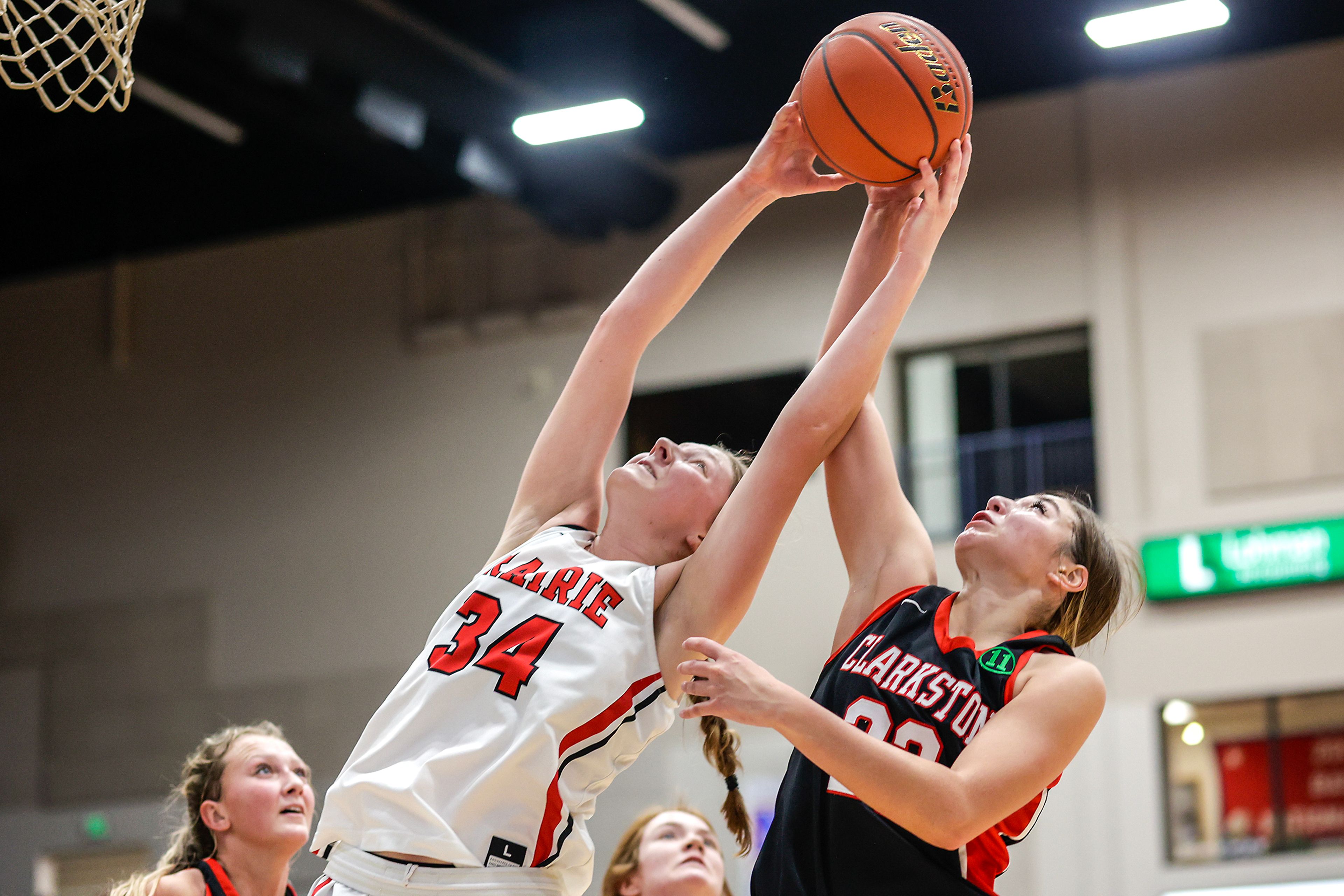 Prairie guard Kylie Schumacher grabs a rebound over Clarkston wing Alahondra Perez during Wednesday’s girls basketball semifinal in the Avista Holiday Tournament at the P1FCU Activity Center on the campus of Lewis-Clark State College.