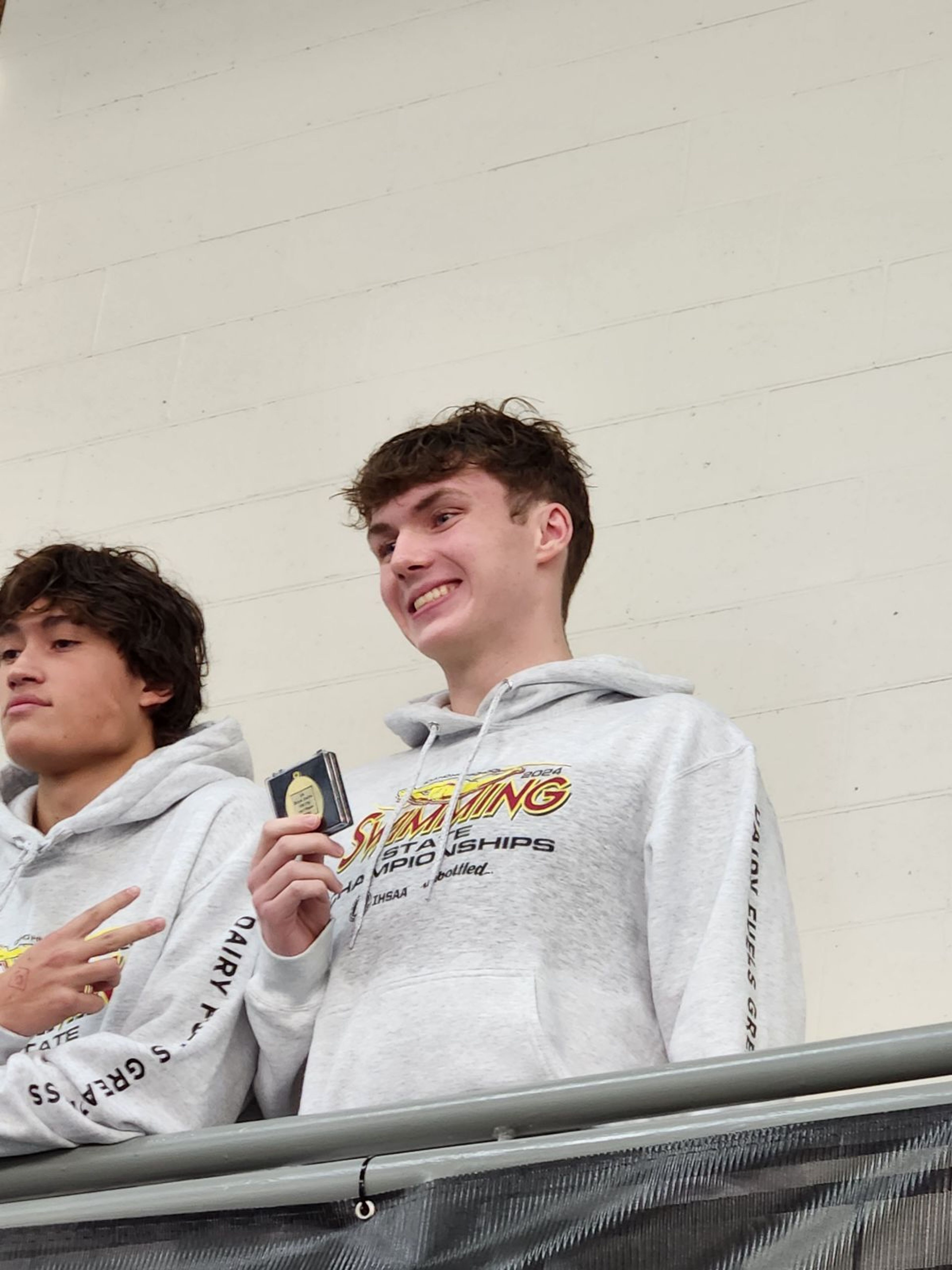 Moscow’s Noah Crossler, right, poses with a medal at the Idaho Class 5A state swim meet Saturday at Boise’s West Ada YMCA.