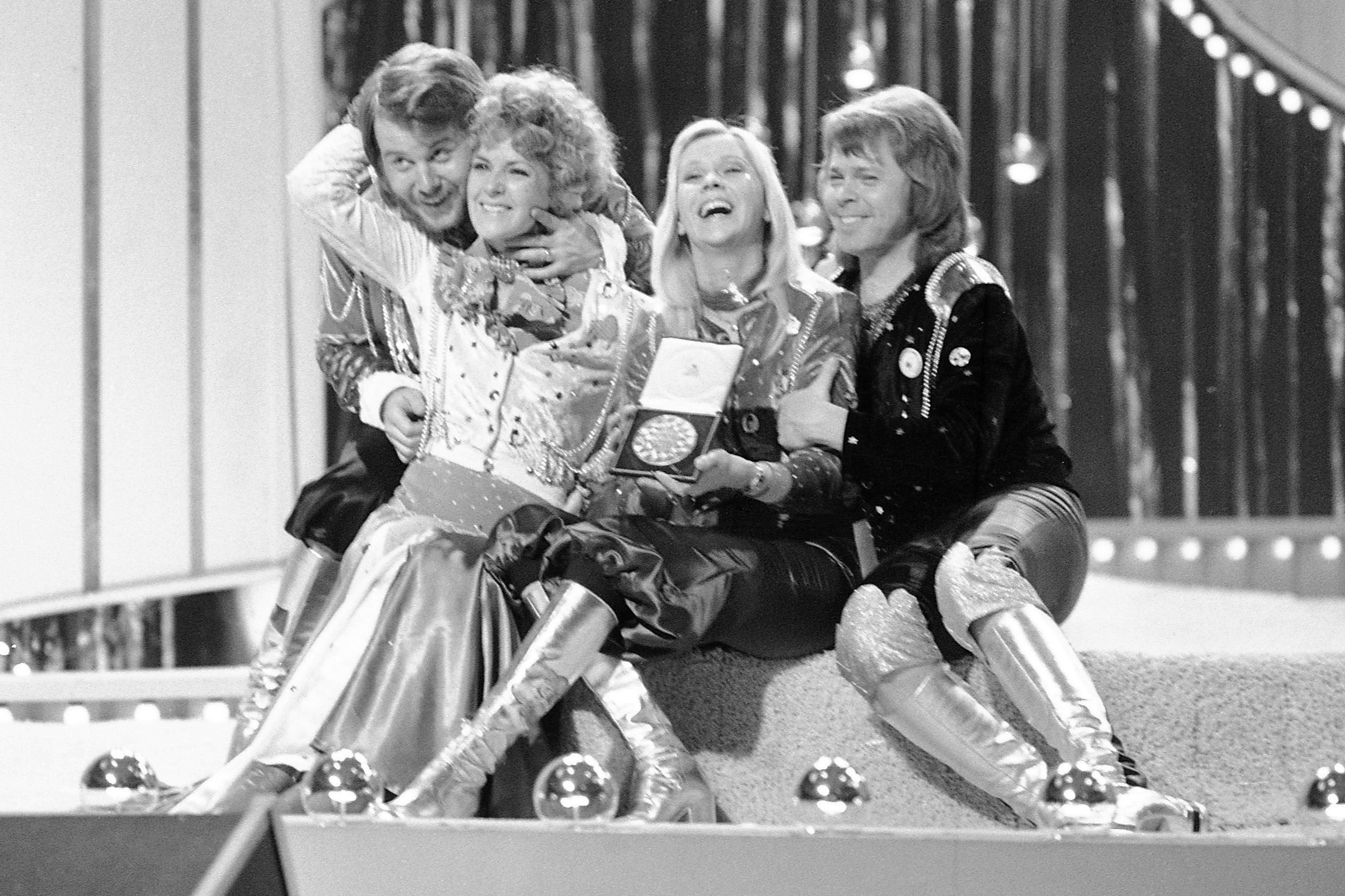 FILE - Swedish pop group ABBA celebrate winning the 1974 Eurovision Song Contest on stage at the Brighton Dome in England with their song "Waterloo", April 6, 1974. The four members of the Swedish pop quartet who triumphed at the 1974 Eurovision Song Contest with the peppy love song “Waterloo” will be given one of the most prestigious knighthoods in Sweden at a ceremony on Friday, May 31, 2024.