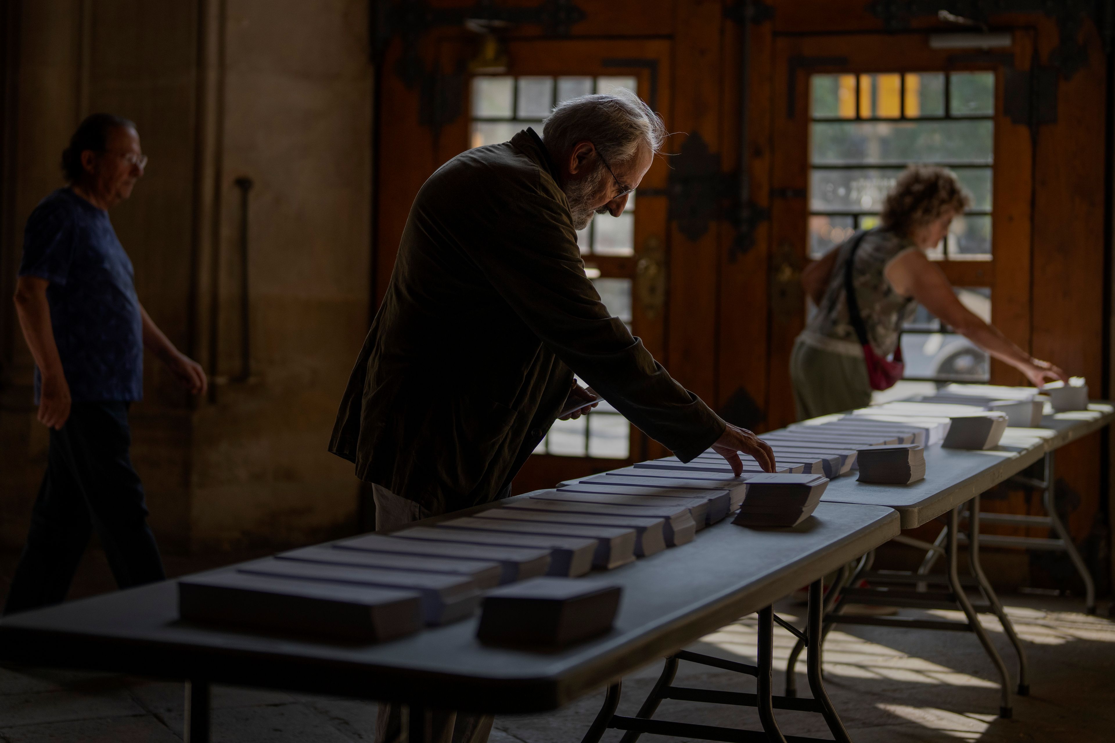 People choose their ballots for the European Parliament election, in Barcelona, Spain, Sunday, June 9, 2024. Polling stations have opened across Europe as voters from 20 countries cast ballots in elections that are expected to shift the European Union’s parliament to the right and could reshape the future direction of the world’s biggest trading bloc.