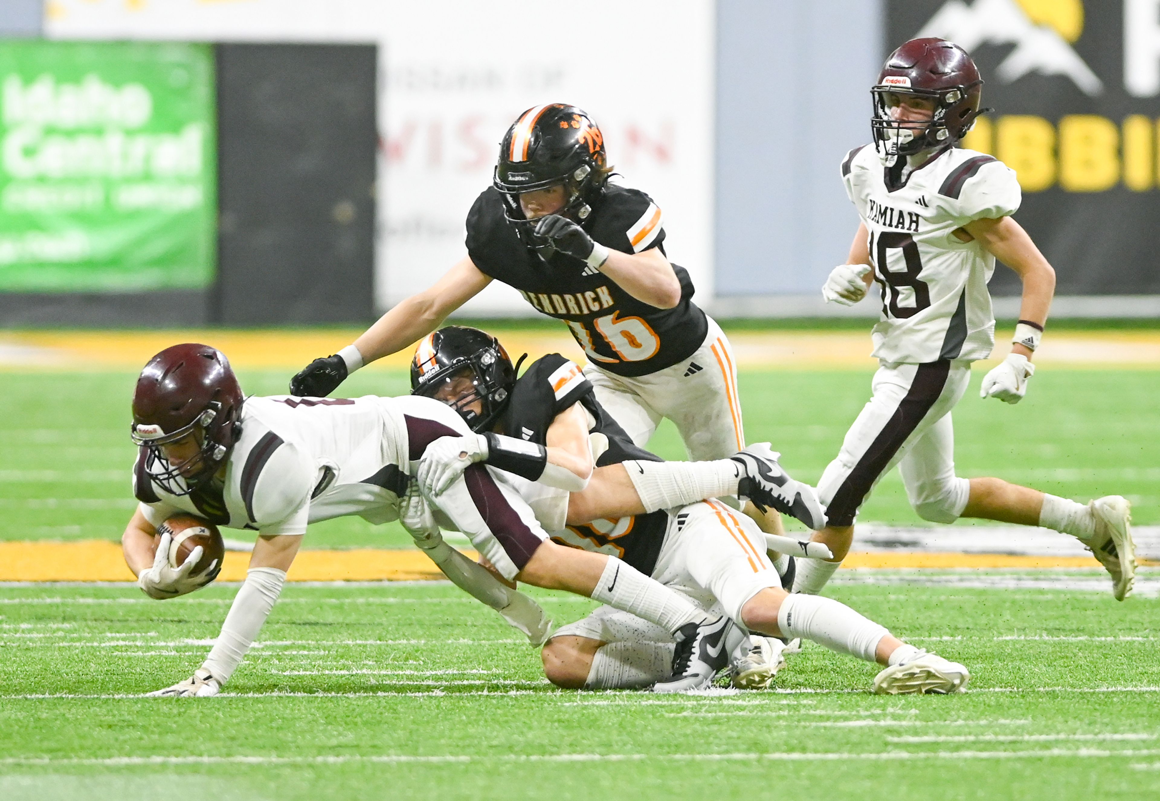 Kamiah’s Lawson Landmark is tackled by Kendrick’s Cade Silflow during an Idaho Class 2A state quarterfinal game at the P1FCU Kibbie Dome in Moscow.