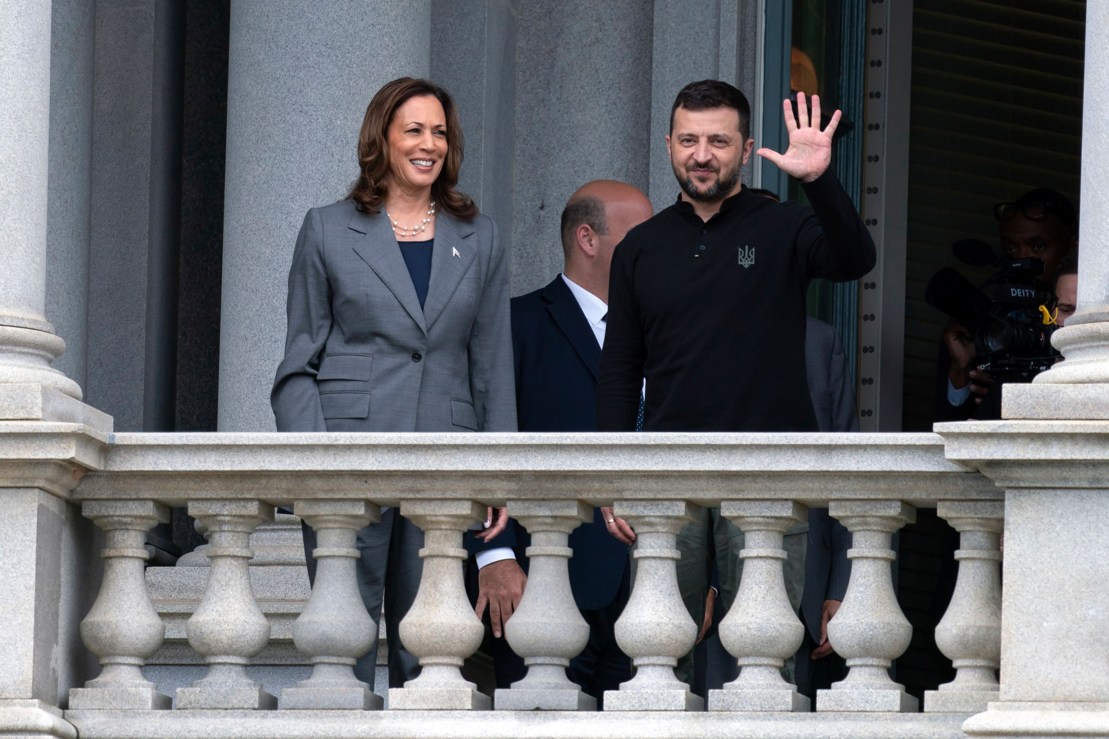 Vice President Kamala Harris accompanied by Ukraine's President Volodymyr Zelenskyy, waves from the balcony of the Eisenhower Executive Office Building on the White House complex in Washington, Thursday, Sept. 26, 2024. (AP Photo/Jose Luis Magana)