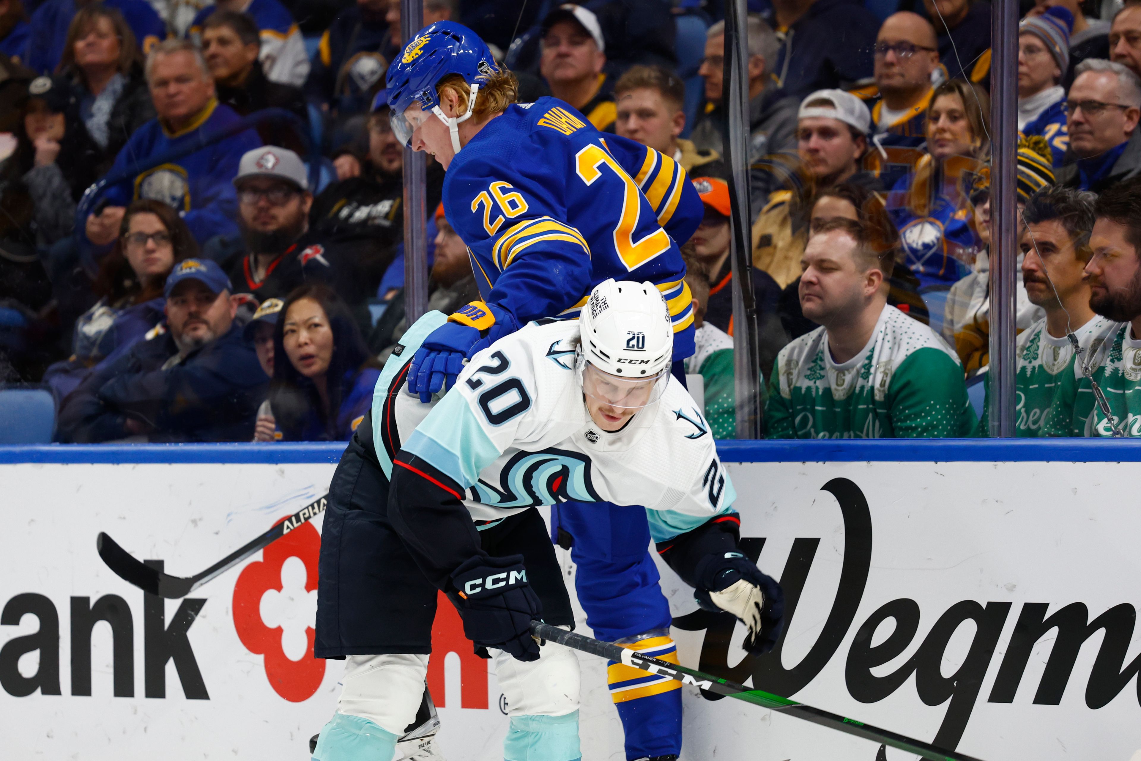 Buffalo Sabres defenseman Rasmus Dahlin (26) and Seattle Kraken right wing Eeli Tolvanen (20) collide behind the net during the second period of an NHL hockey game, Tuesday, Jan. 10, 2023, in Buffalo, N.Y. (AP Photo/Jeffrey T. Barnes)