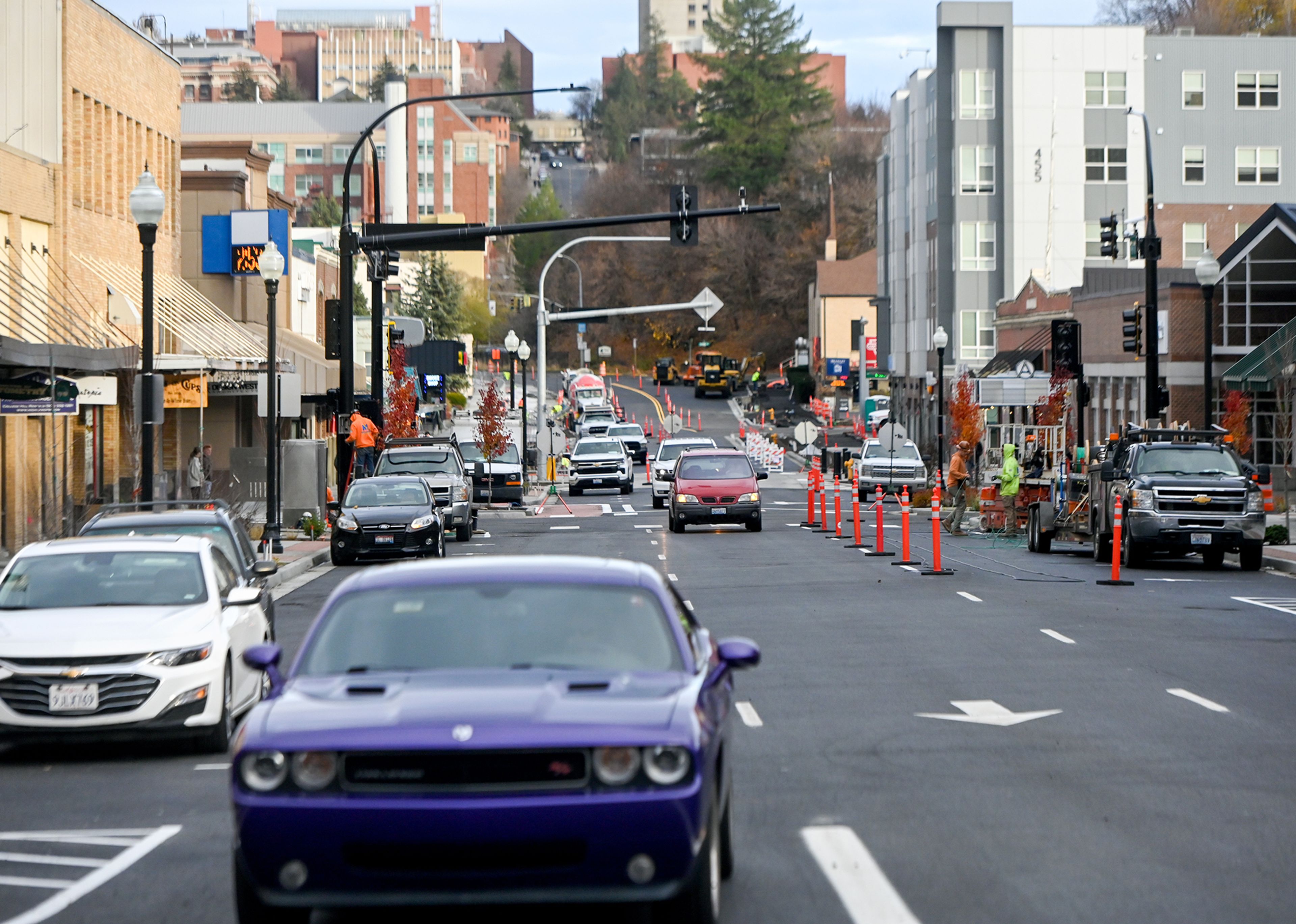 Cars move down Main Street after the road partially reopened to traffic Thursday in Pullman. Work continues in areas of the street, with construction expected to finish in late November.