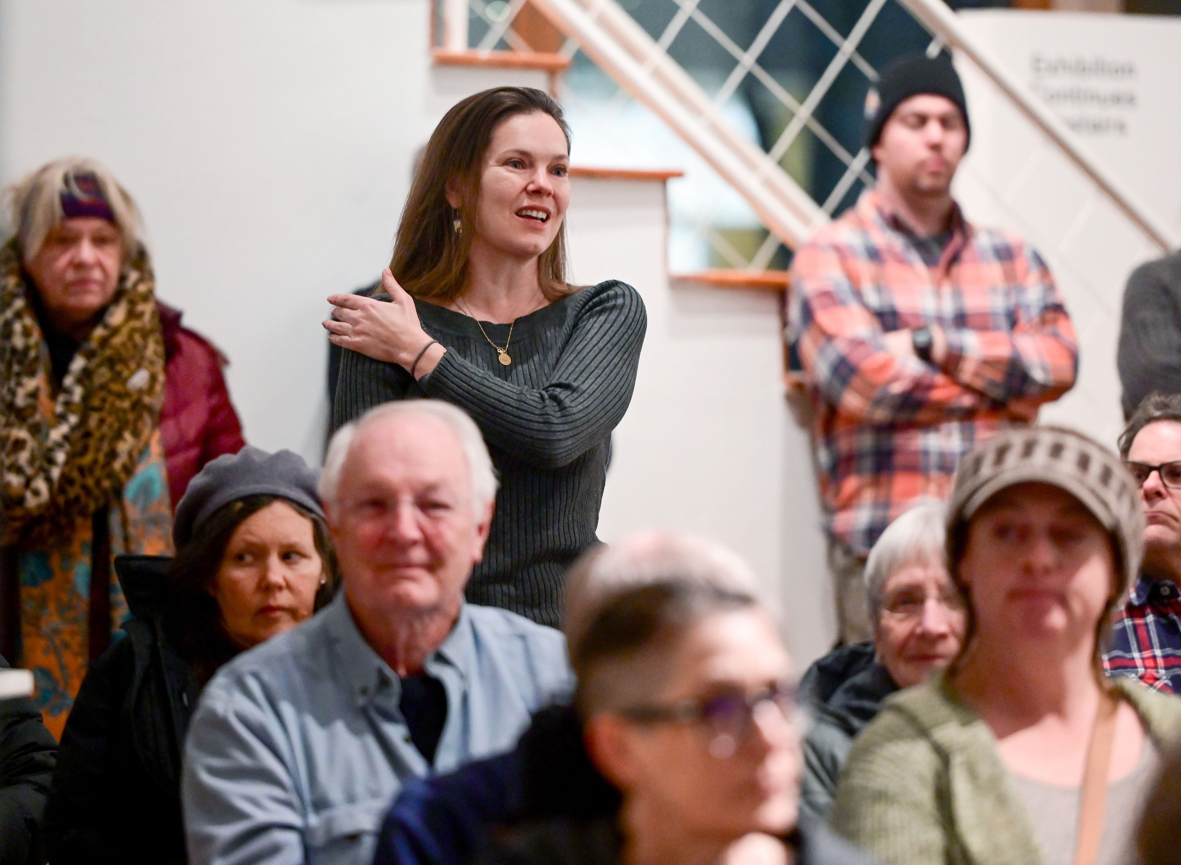 Bridgette Schnider, of Color & Gold LLC, stands to ask a question about the future of the Moscow Contemporary gift store during a town hall at the gallery on Thursday.