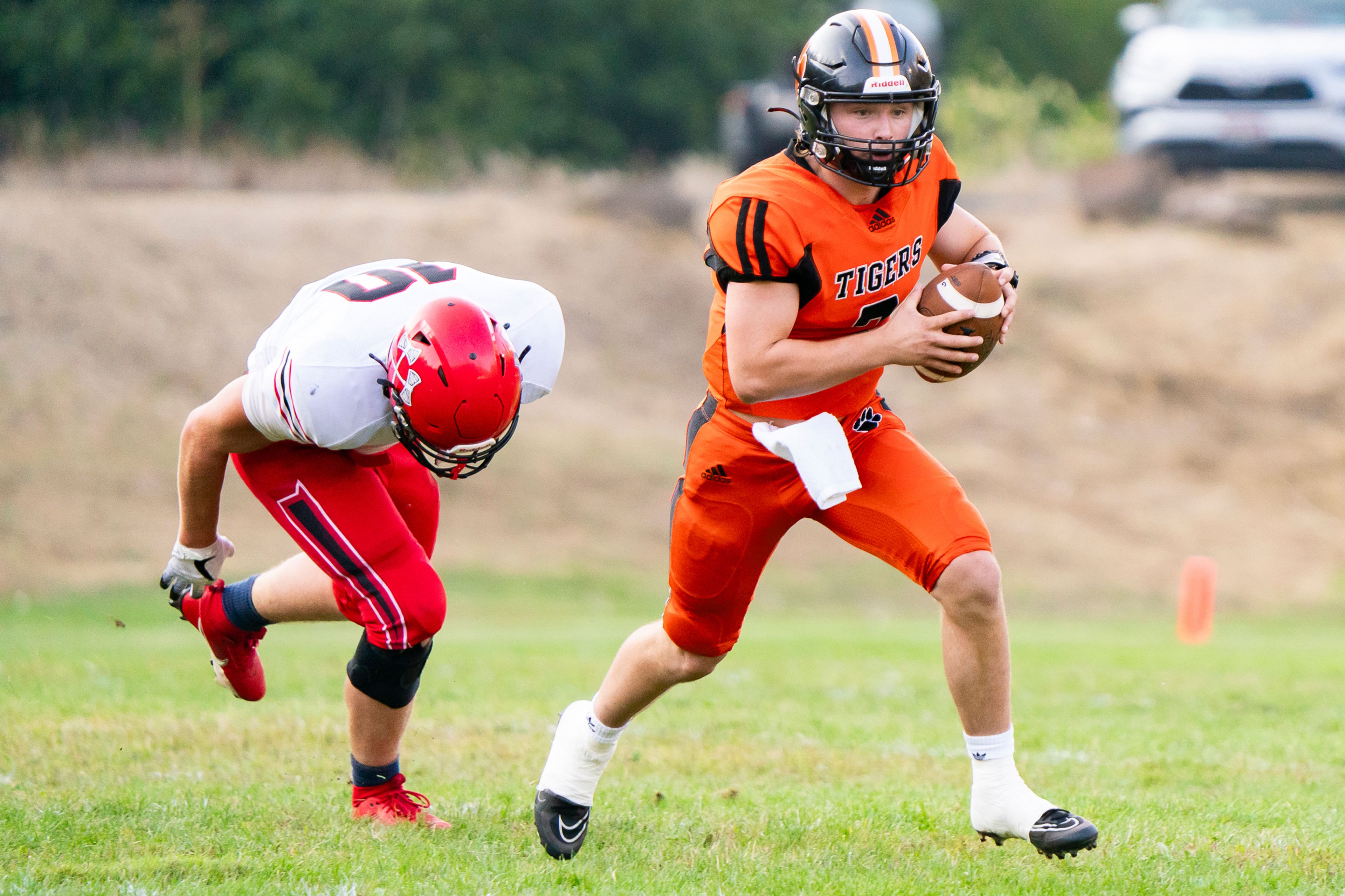 Kendrick’s Ty Koepp, right, runs the ball during a game against Council on Aug. 25 in Kendrick.