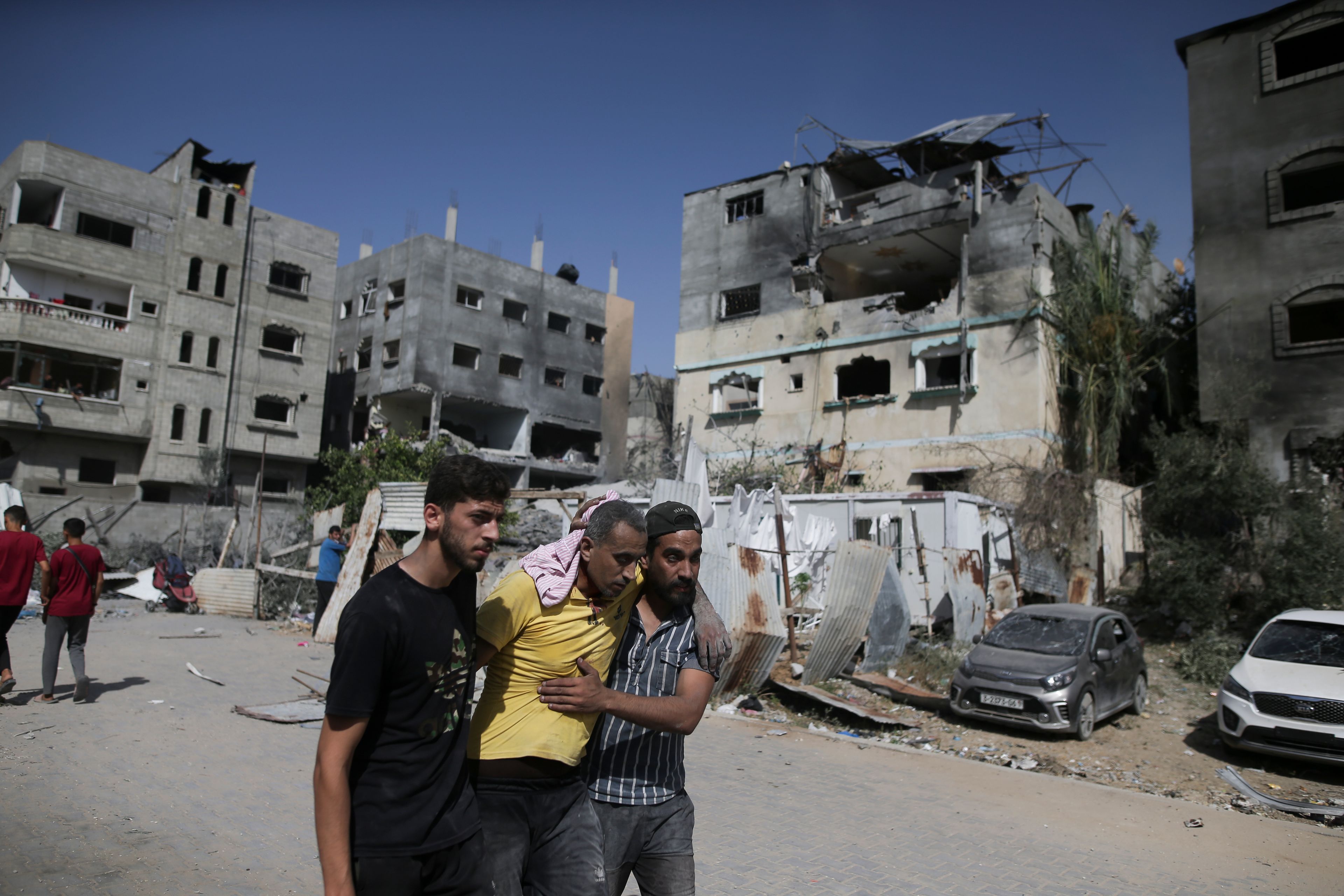 Palestinians help a wounded man after Israeli strikes in Nuseirat refugee camp, Gaza Strip, Saturday, June 8, 2024.