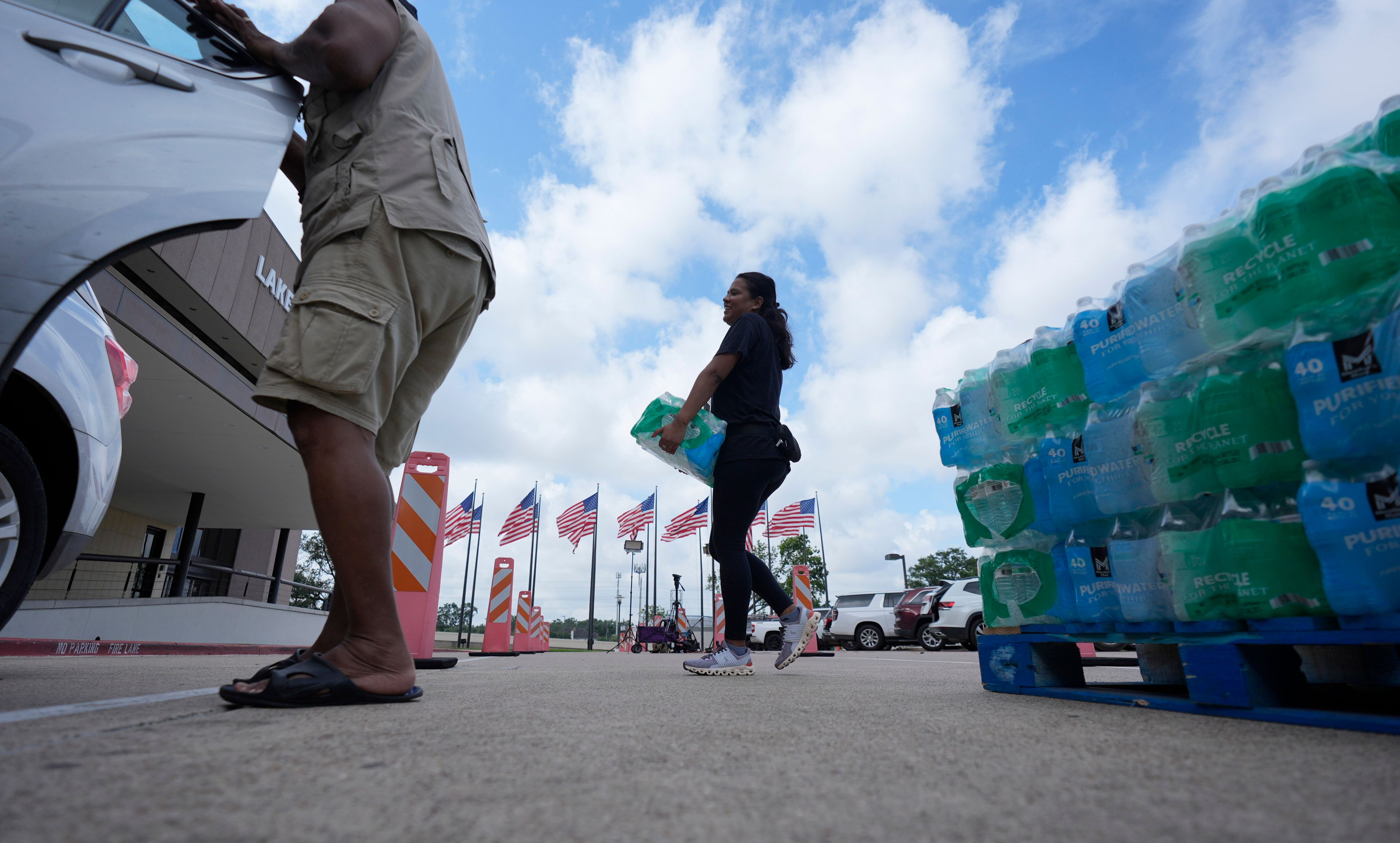 Staff at Lakewood Church hand out water and operate a cooling station in Houston, Tuesday, July 9, 2024. The effects of Hurricane Beryl left most in the area without power. (AP Photo/Eric Gay)