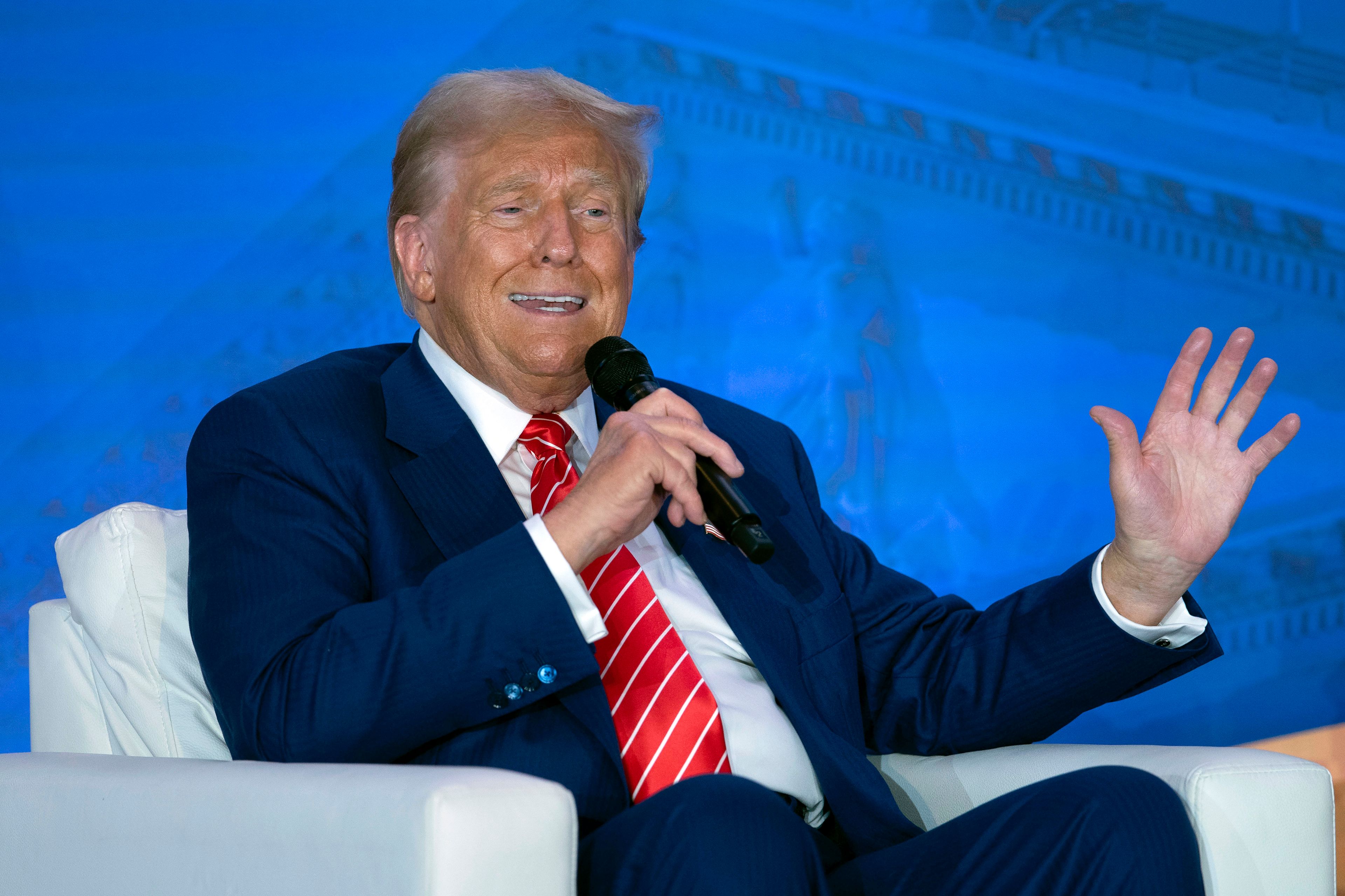 Republican presidential nominee former President Donald Trump speaks with Moms for Liberty co-founder Tiffany Justice during an event at the group's annual convention in Washington, Friday, Aug. 30, 2024.