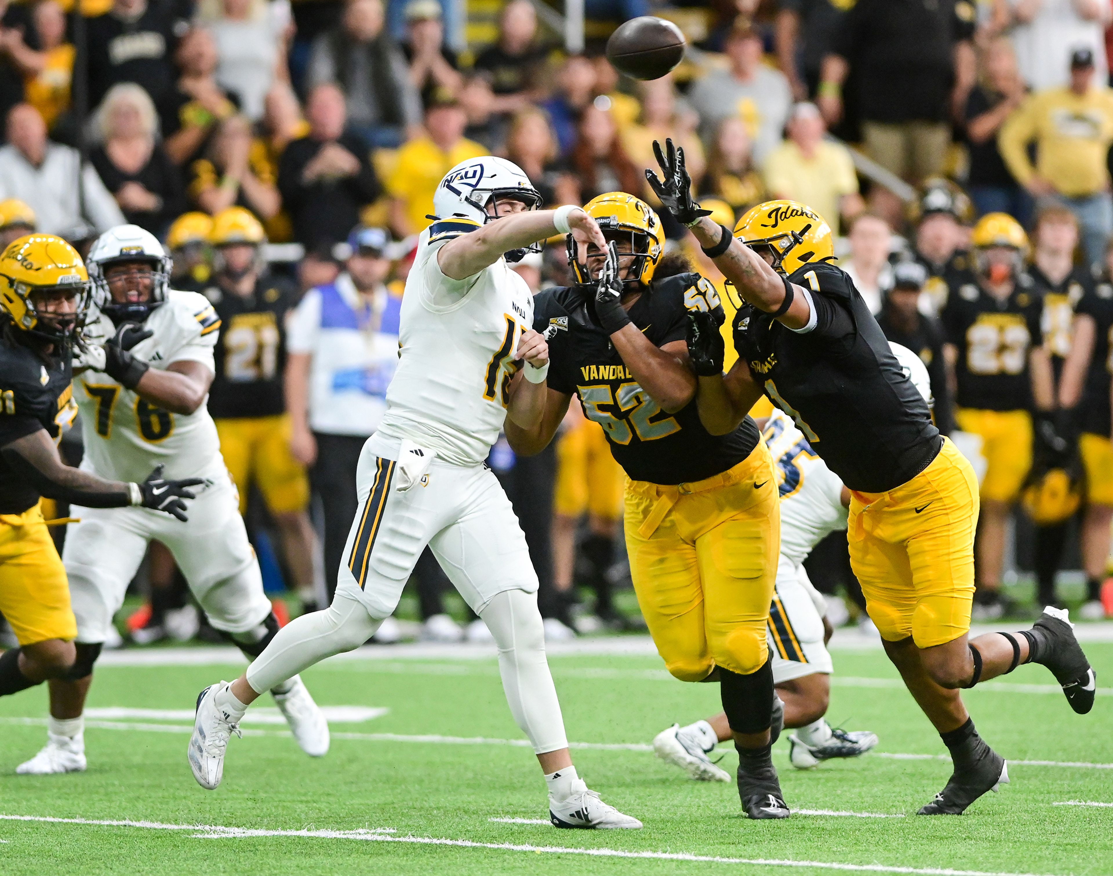 Idaho defensive lineman Dallas Afalava and Idaho defensive lineman Keyshawn James-Newby attempt to block a pass by Northern Arizona quarterback PJ London Saturday at the P1FCU Kibbie Dome in Moscow.,