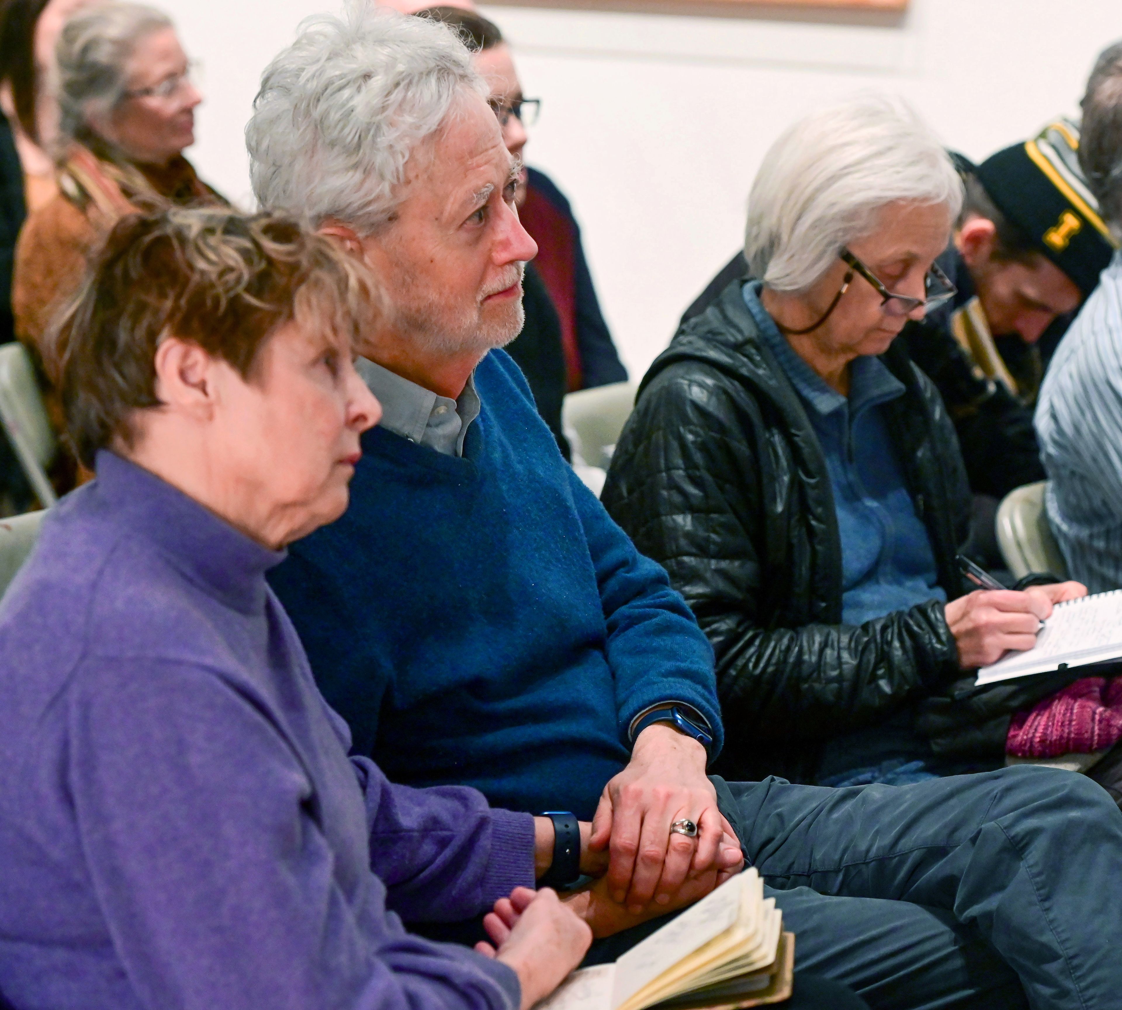 Artist Gerri Sayler, left, holds Kenton Bird’s hand during an emotional moment of a town hall for the future of Moscow Contemporary on Thursday. Both have a strong history with the gallery and had tears come to their eyes during the meeting.