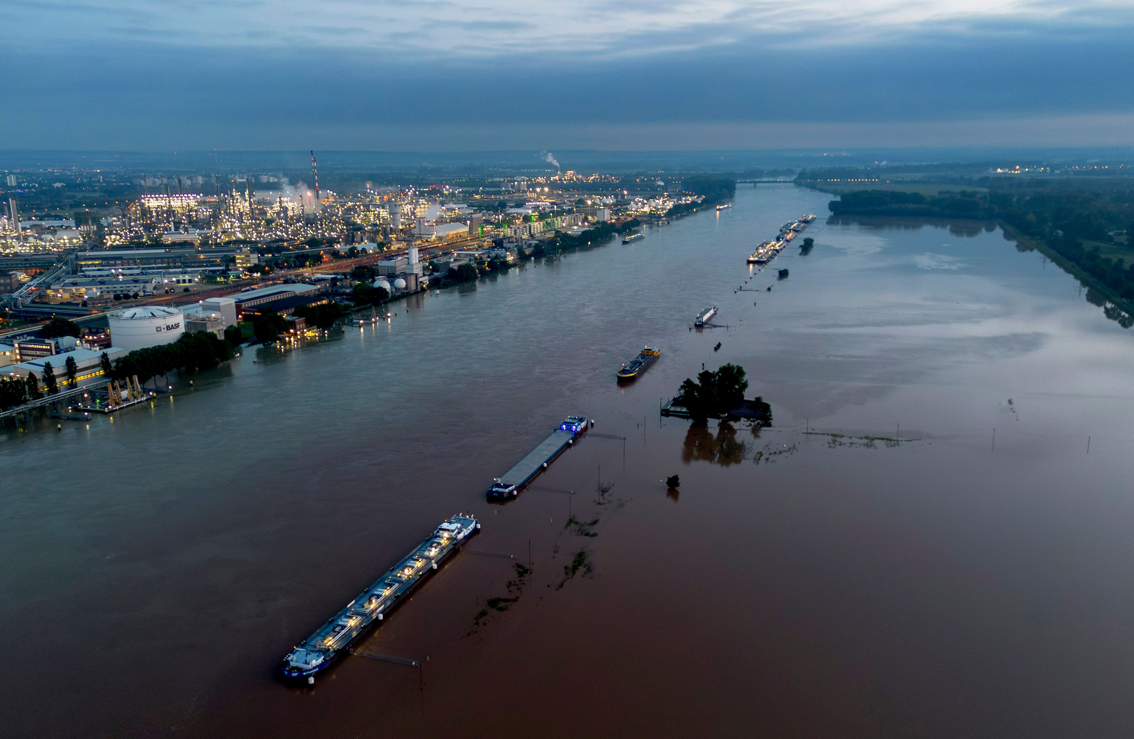 Cargo ships park at the bank of the river Rhine near the BASF chemical plant in Ludwigshafen, Germany, Tuesday, June 4, 2024. The Rhine left its banks after heavy rain falls in southern Germany during the last days.