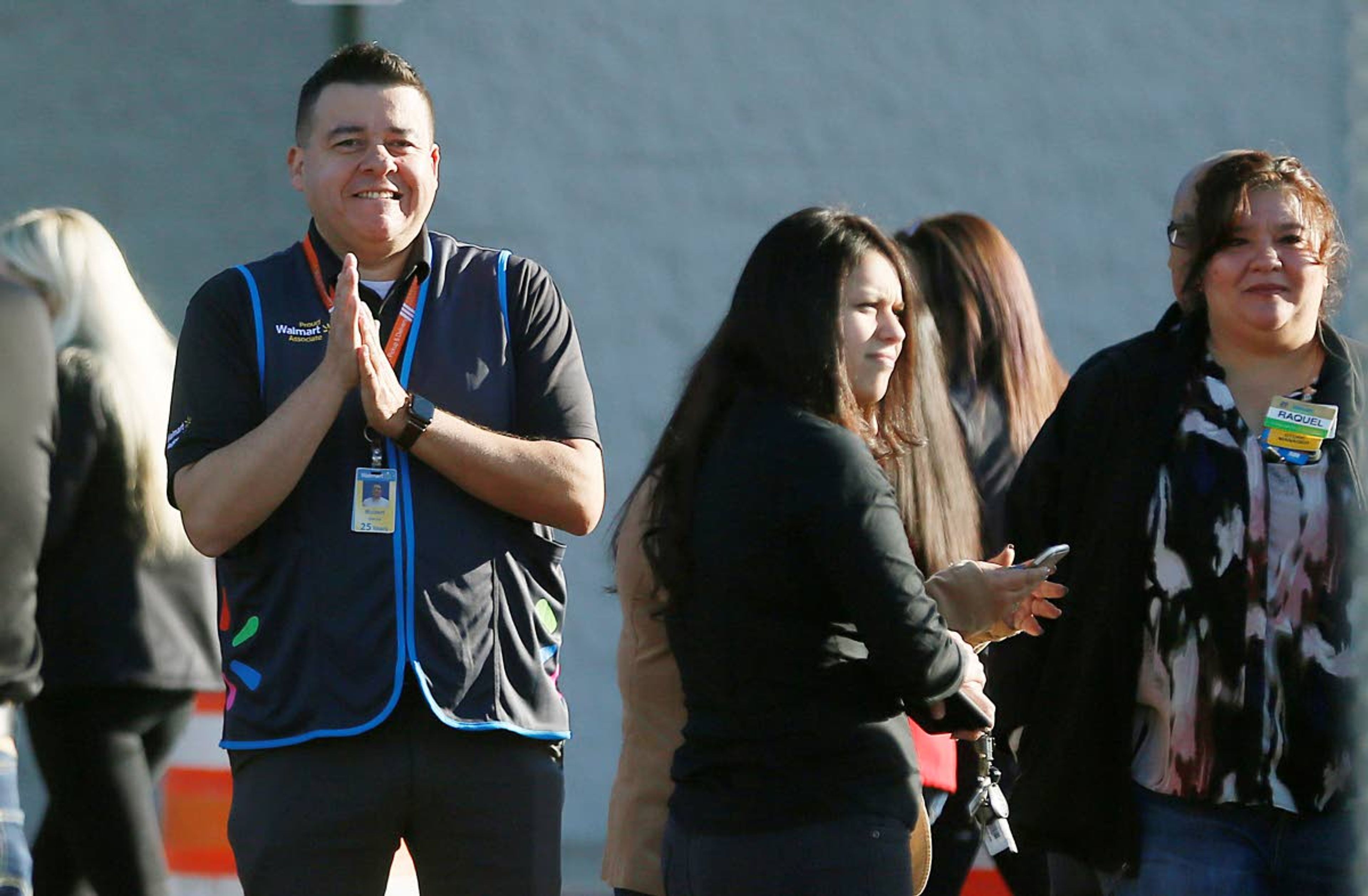 Employees gather Thursday outside the Walmart store for a reopening event in El Paso, Texas. The store had been closed since August, when a gunman opened fire at the store, killing 22 people.