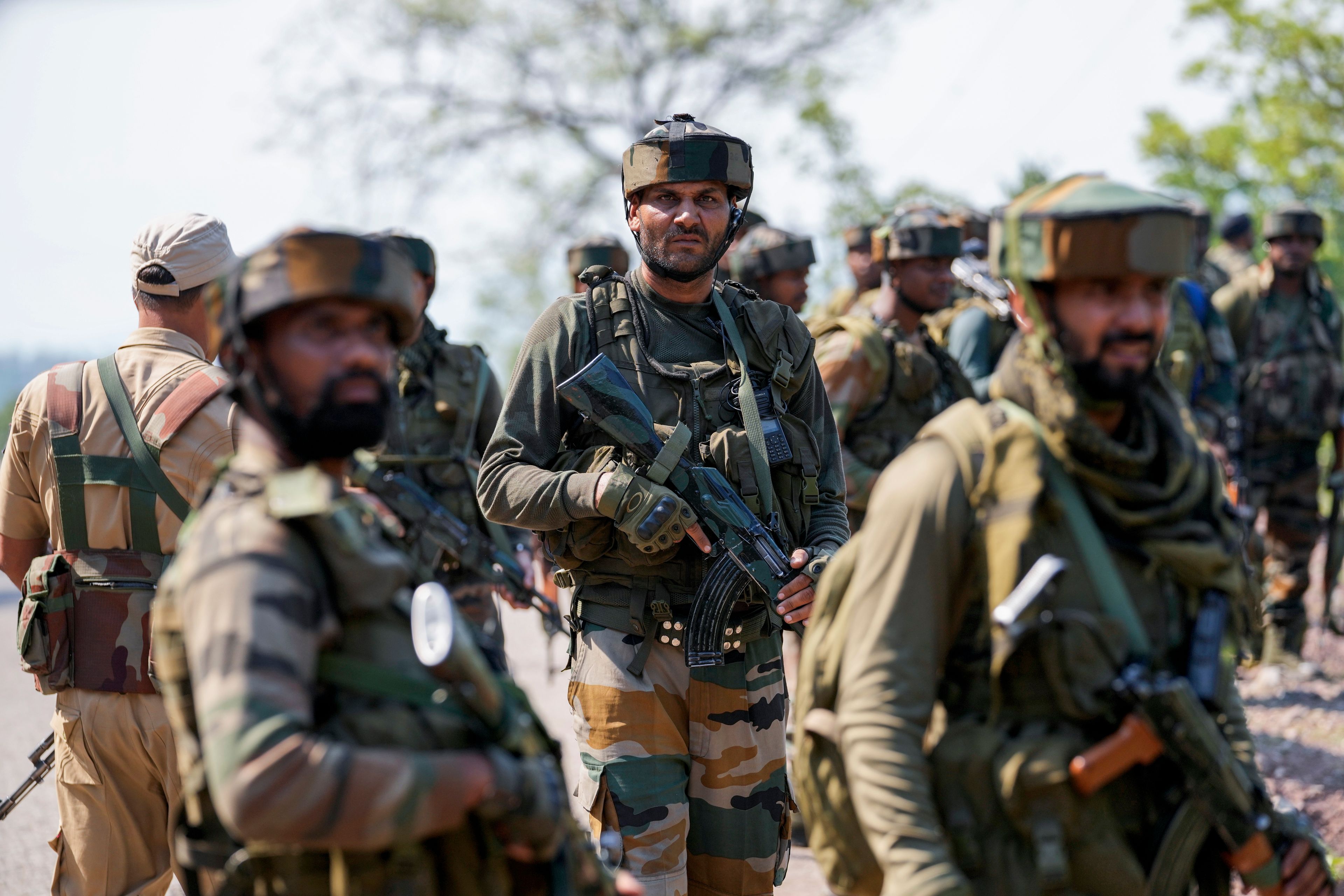 Indian army soldiers patrol the area where a bus fell into a deep gorge on Sunday after being fired at by suspected militants in Reasi district, Jammu and Kashmir, Monday, June 10, 2024. The bus was carrying pilgrims to the base camp of the famed Hindu temple Mata Vaishno Devi when it came under attack killing at least nine people.