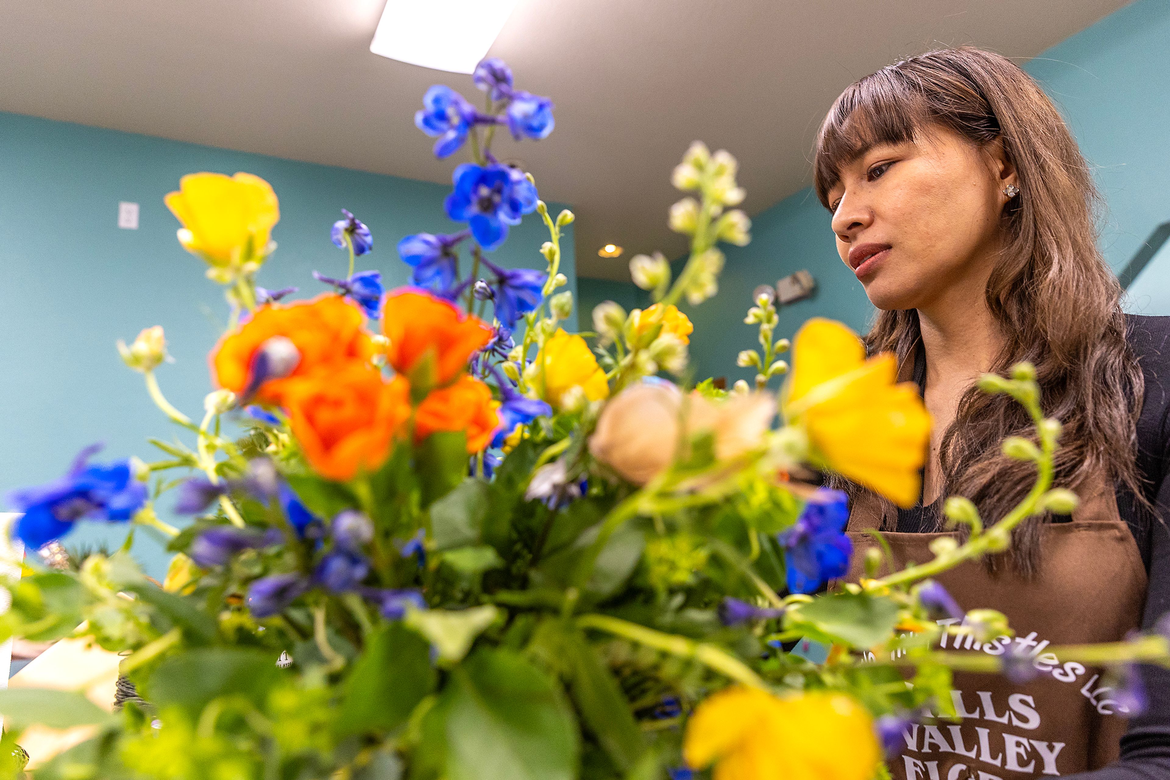 Sutthiramon Evans works on a flower arrangement at Hills Valley Floral Tuesday in Lewiston.