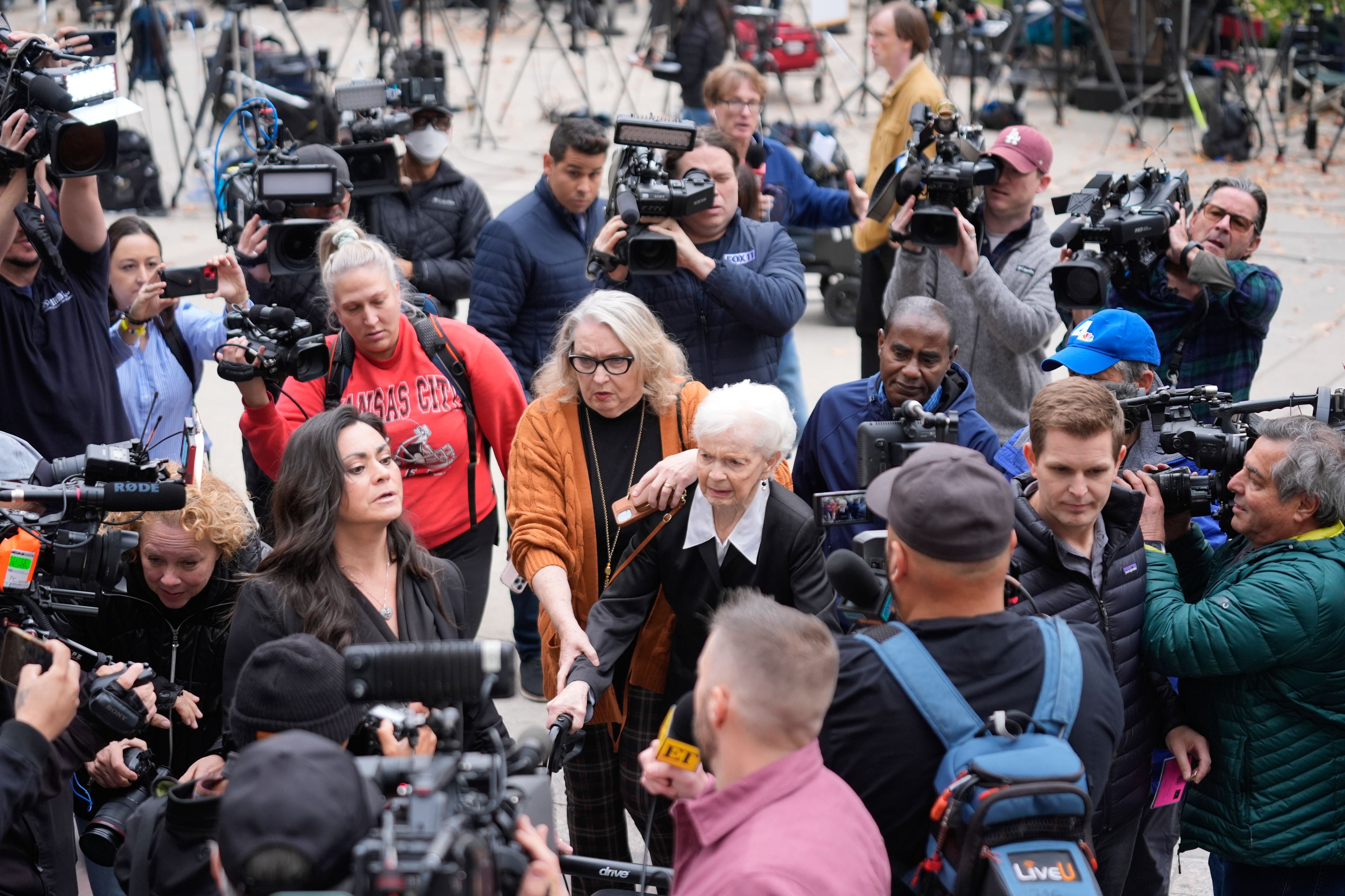 Erik and Lyle Menendez's aunt Joan VanderMolen, center, arrives to attend a hearing at the Van Nuys courthouse in Los Angeles, Monday, Nov. 25, 2024. (AP Photo/Damian Dovarganes)