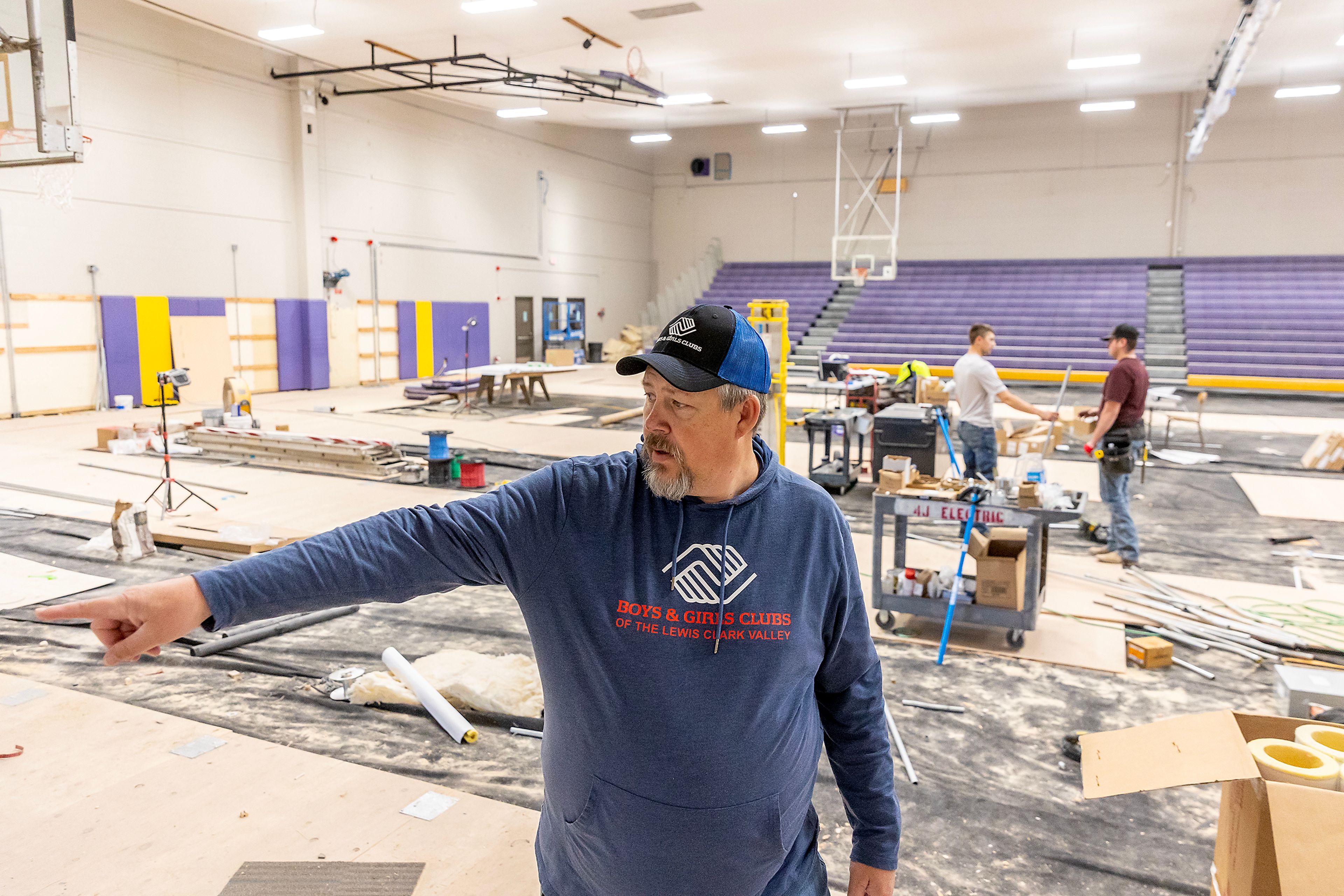 Jon Evans stands in the gymnasium at Booth Hall undergoing renovations Wednesday in Lewiston.