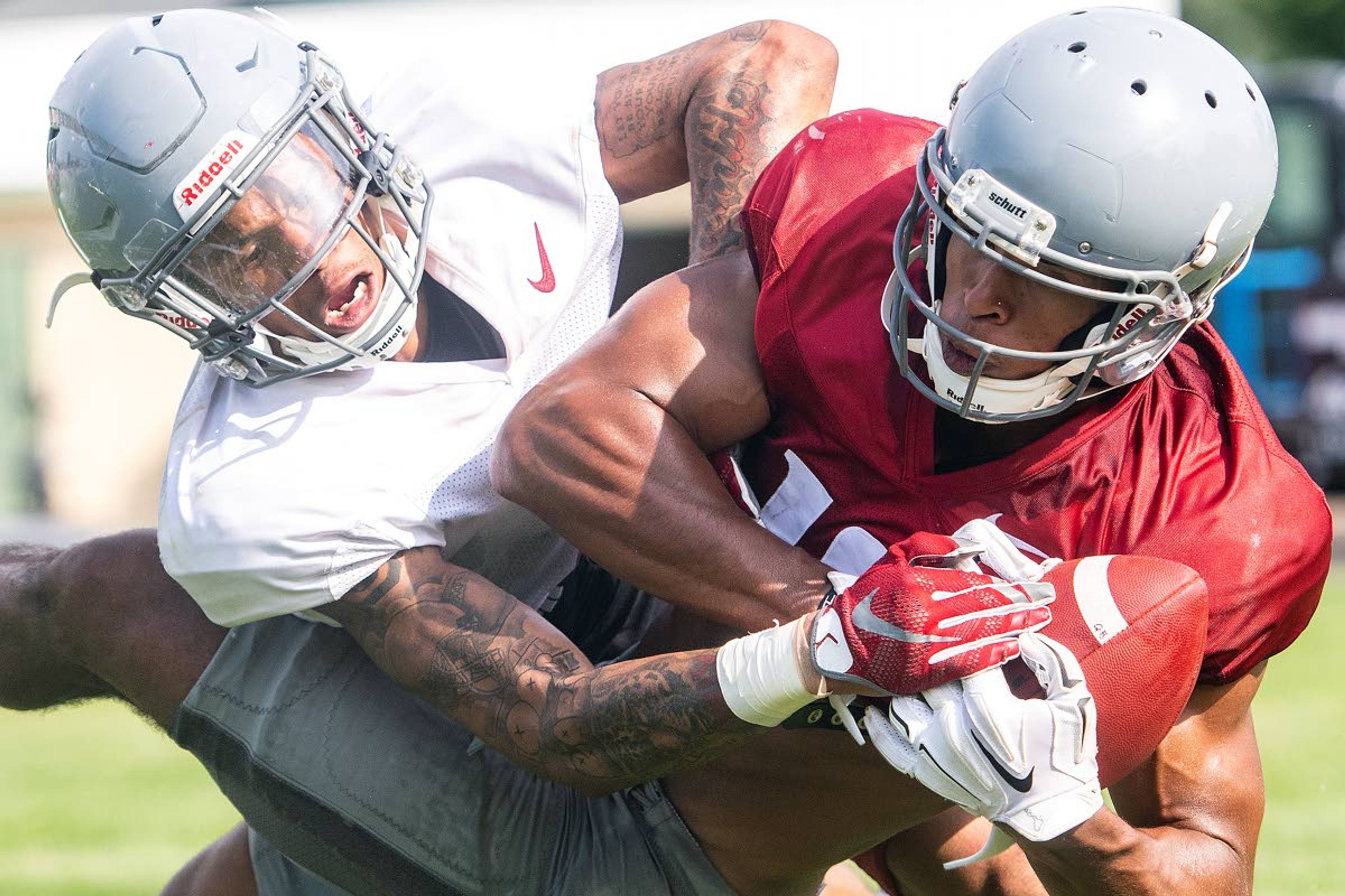 Washington State receiver Dezmon Patmon fends off defensive back Derrick Langford as he catches a touchdown pass during team drills on Tuesday afternoon in Lewiston.