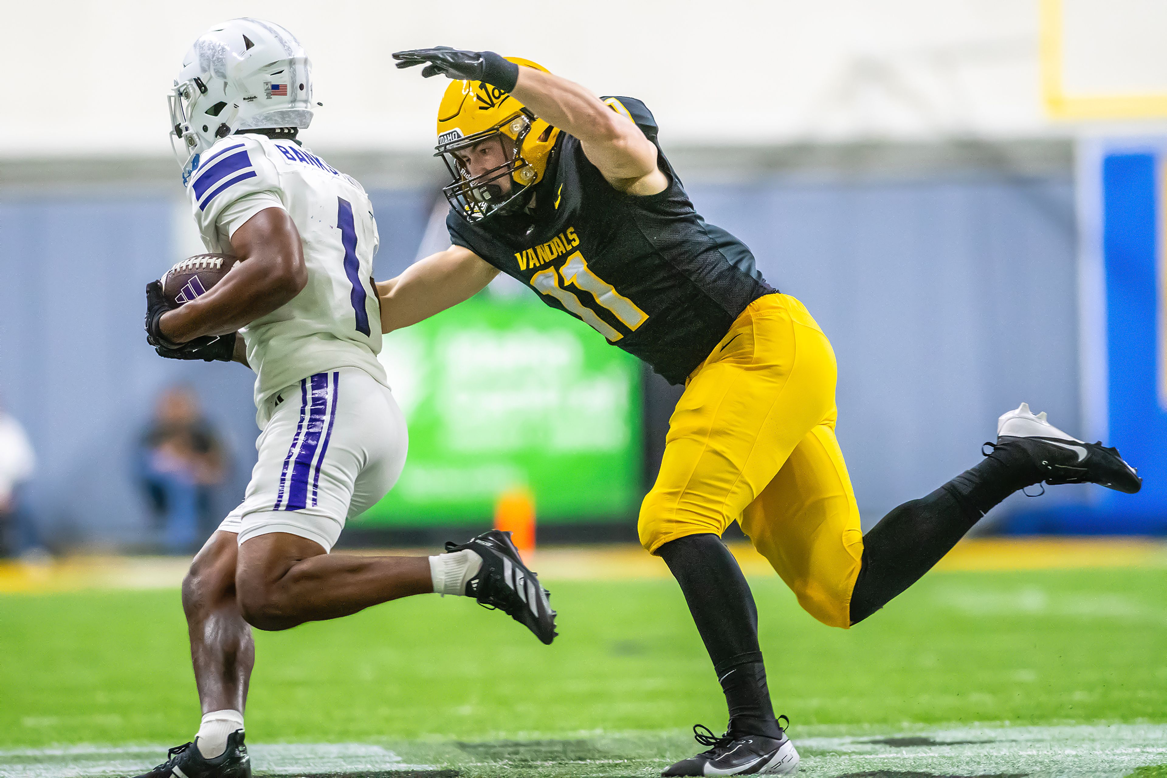 Idaho linebacker Zach Johnson chases after Weber State running back Damon Bankston during a quarter of a Big Sky conference game Saturday at the P1FCU Kibbie Dome in Moscow.