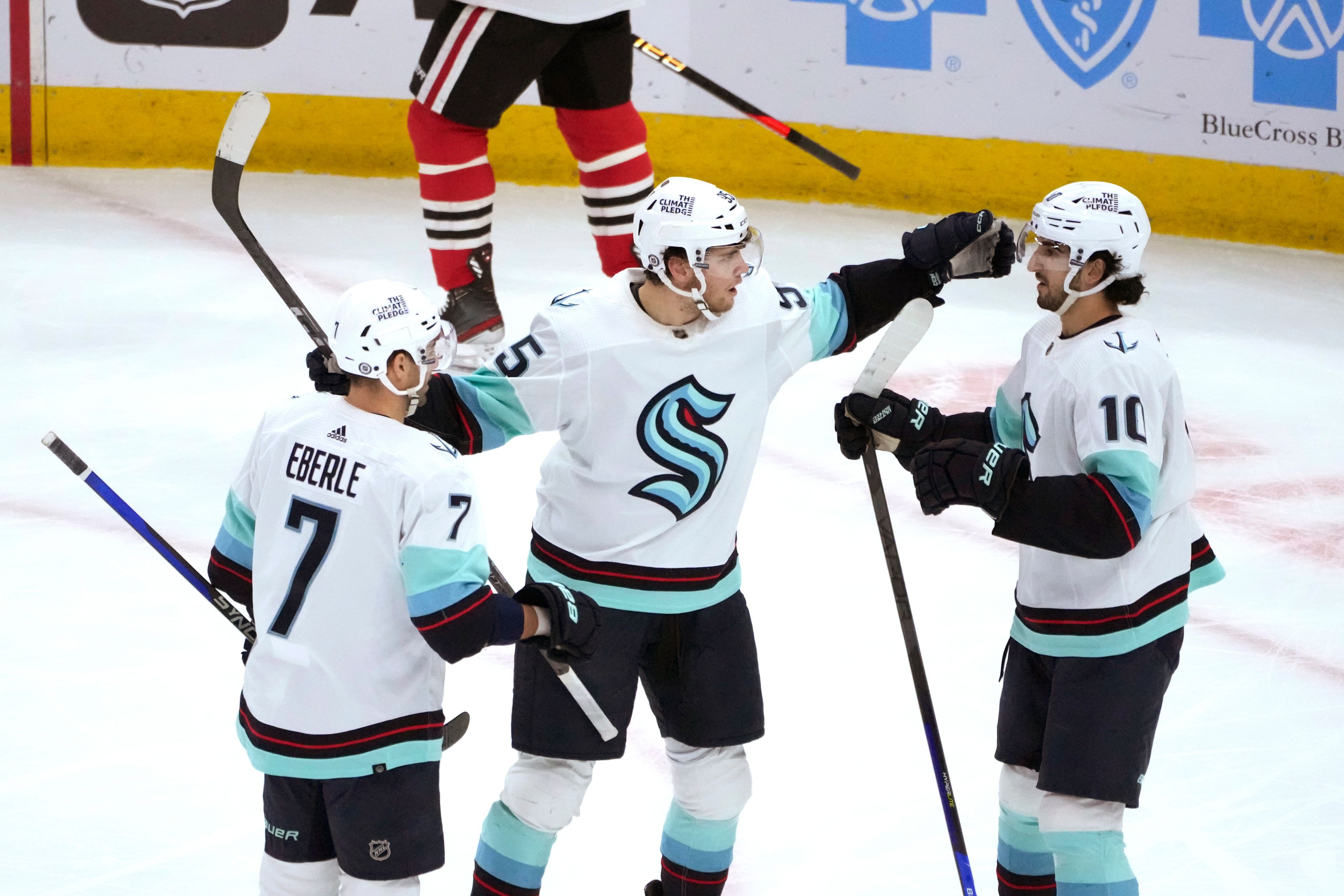 Seattle Kraken's Andre Burakovsky, center, celebrates his goal with Jordan Eberle (7) and Matty Beniers during the first period of the team's NHL hockey game against the Chicago Blackhawks on Saturday, Jan. 14, 2023, in Chicago. (AP Photo/Charles Rex Arbogast)