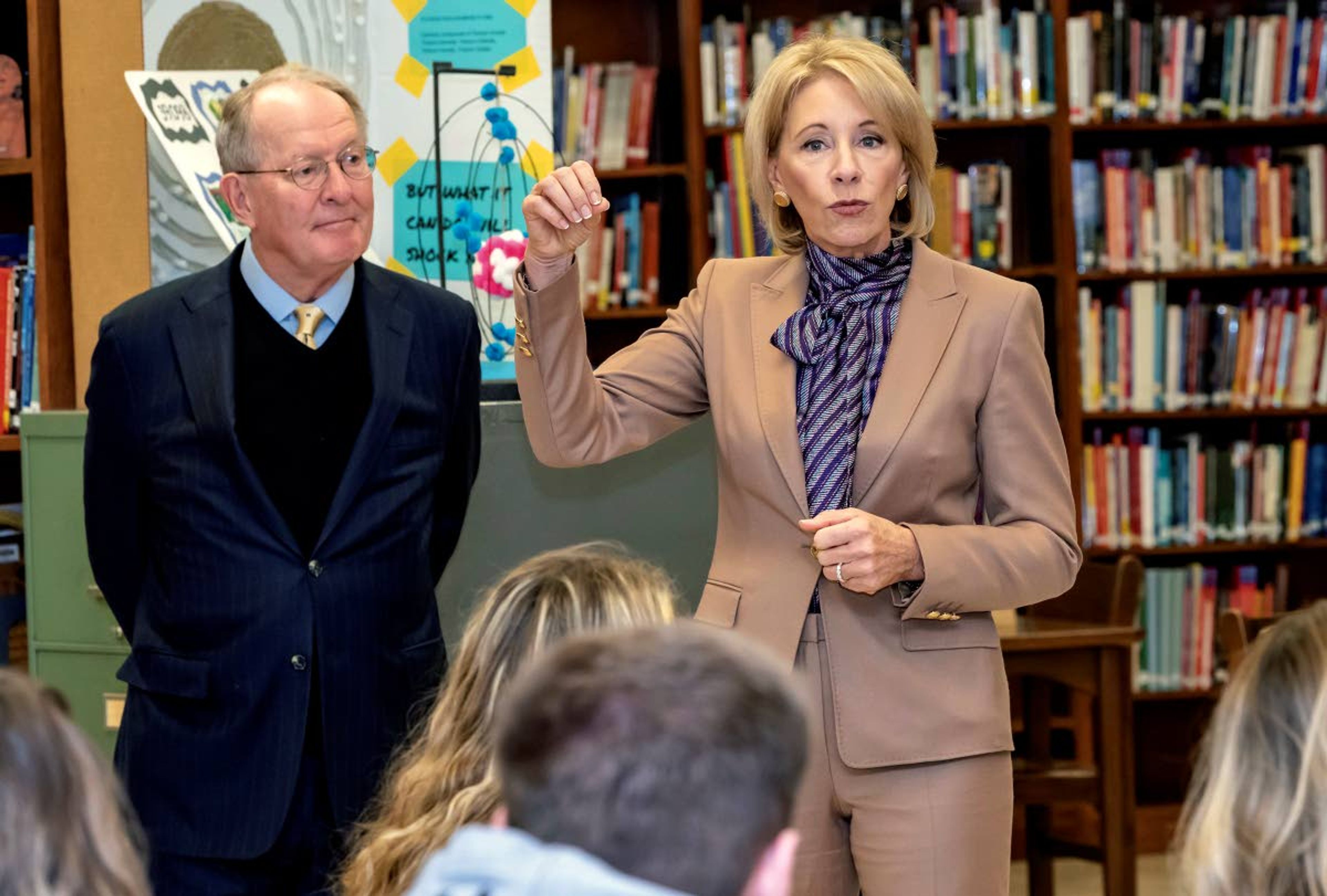 Sen. Lamar Alexander listens as Department of Education Secretary Betsy DeVos speaks to students at Sevier County High School Nov. 13 in Sevierville, Tenn. The pair spoke about the newly launched myStudentAid mobile application.