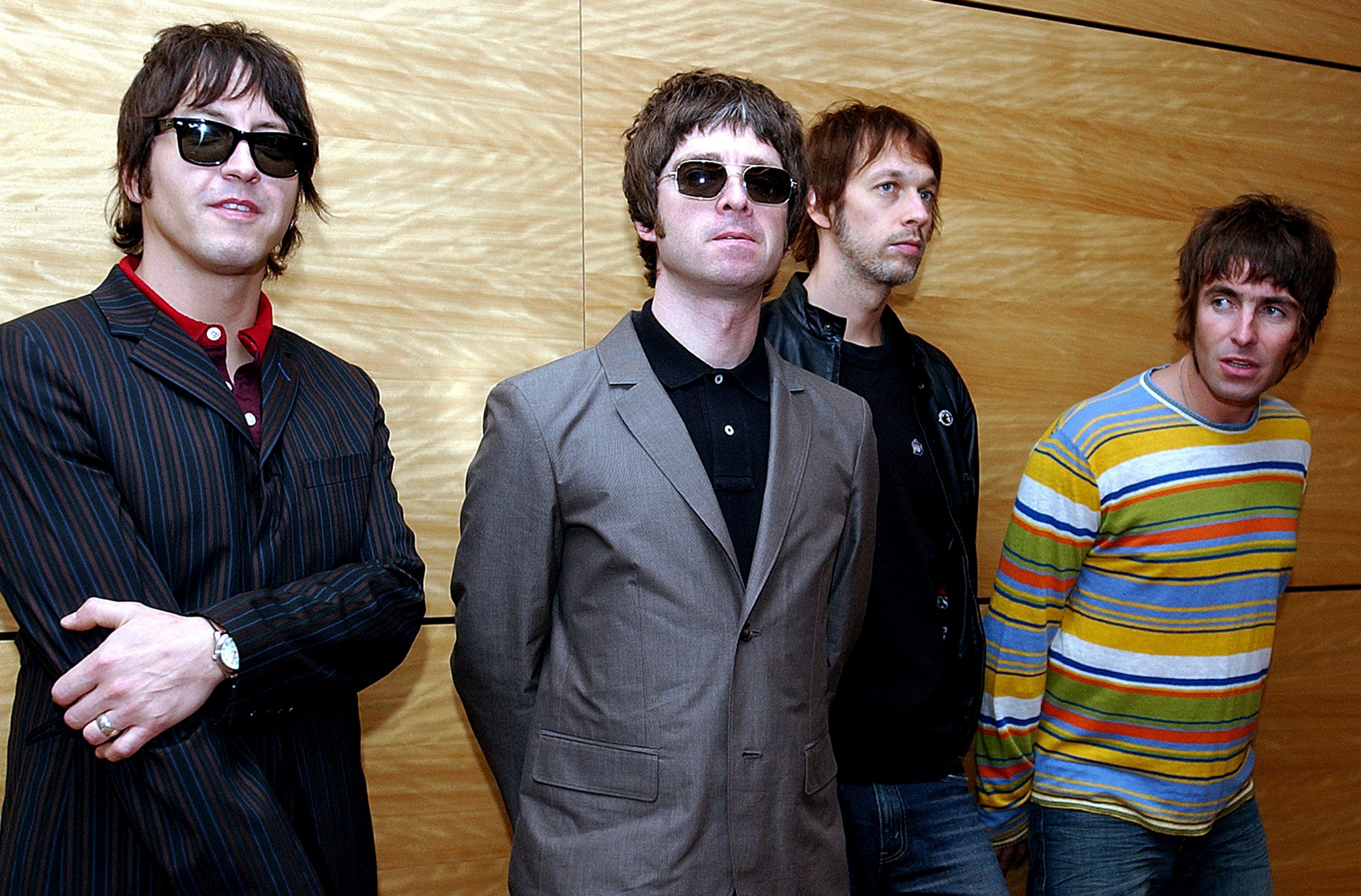 FILE - Members of British rock band Oasis pose for photos ahead of a concert in Hong Kong, Feb. 25, 2006. From left are, Gem Archer, Noel Gallagher, Andy Bell, and Liam Gallagher.