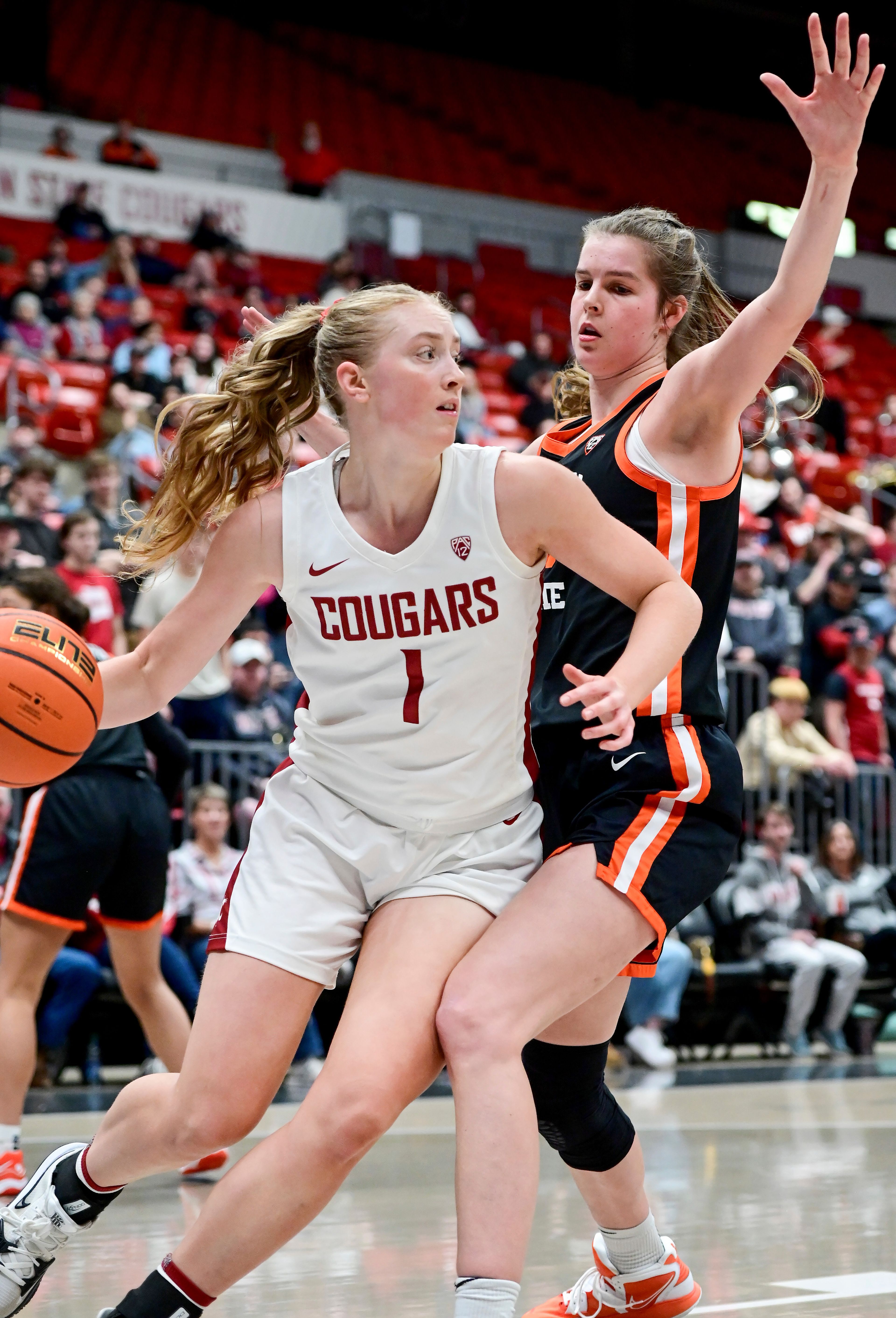 Washington State guard Tara Wallack, left, moves along the sidelines with pressure from Oregon State forward Kelsey Rees,right, during a game Feb. 23 at Beasley Coliseum in Pullman.