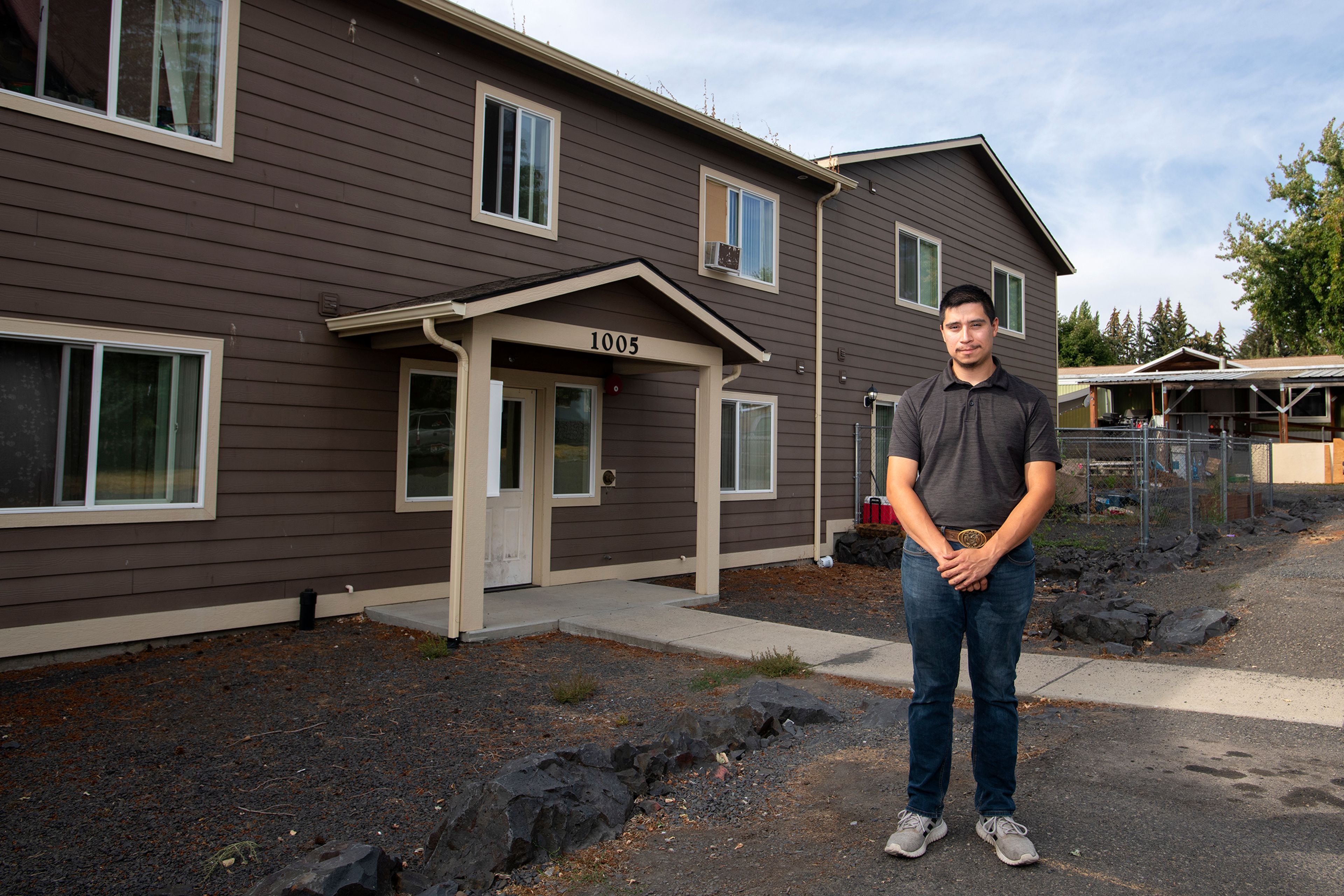 David Gutierrez-Aguirre, of Moscow, stands in front of his current townhouse residence for a portrait as he struggles to find an affordable house to purchase in the area.