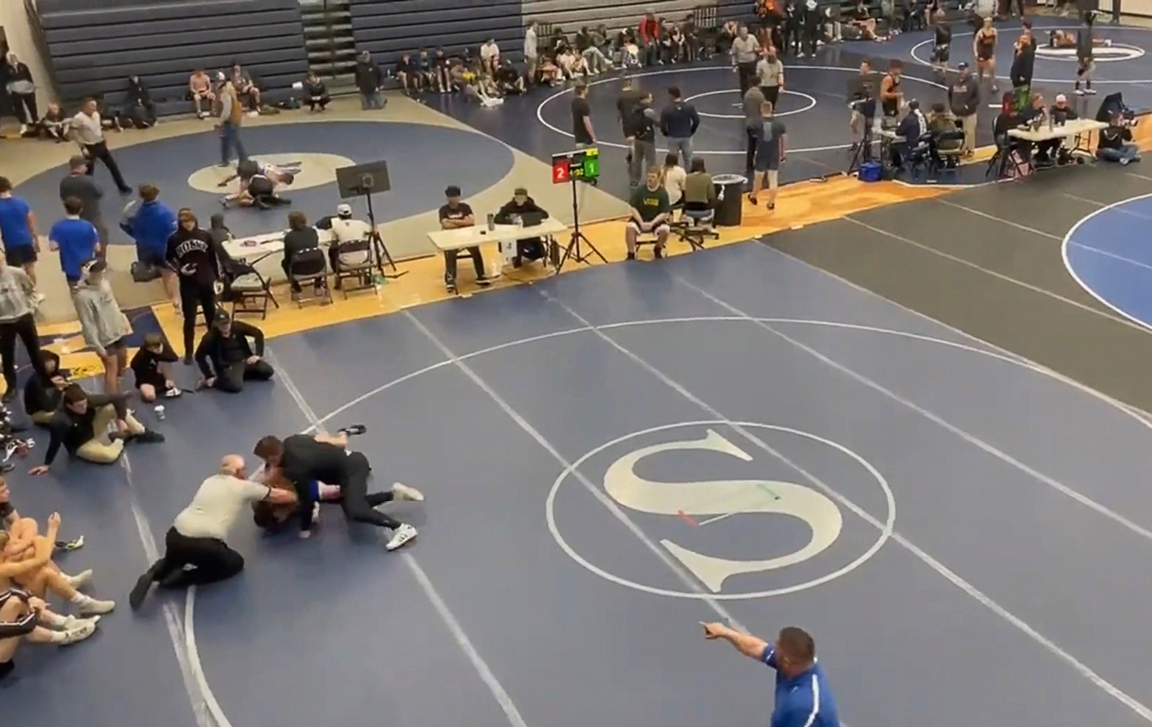 Rocky Mountain High assistant coach Russell Brunson is seen punching a freshman wrestler from Nyssa, Oregon, during a match at the Skyview Duals on Saturday in Nampa.